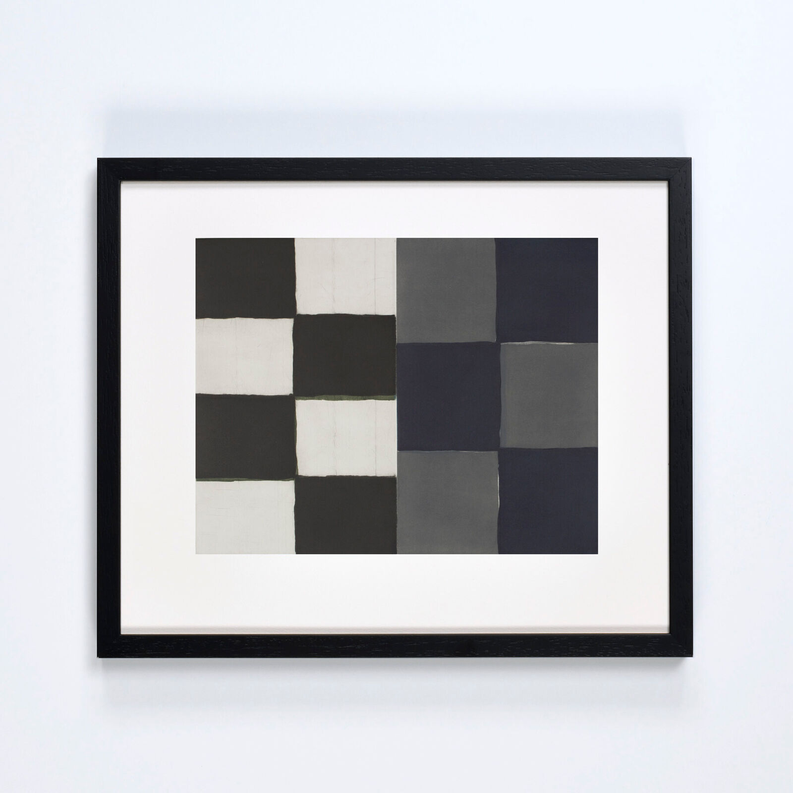 A black and white painting hanging on a wall.