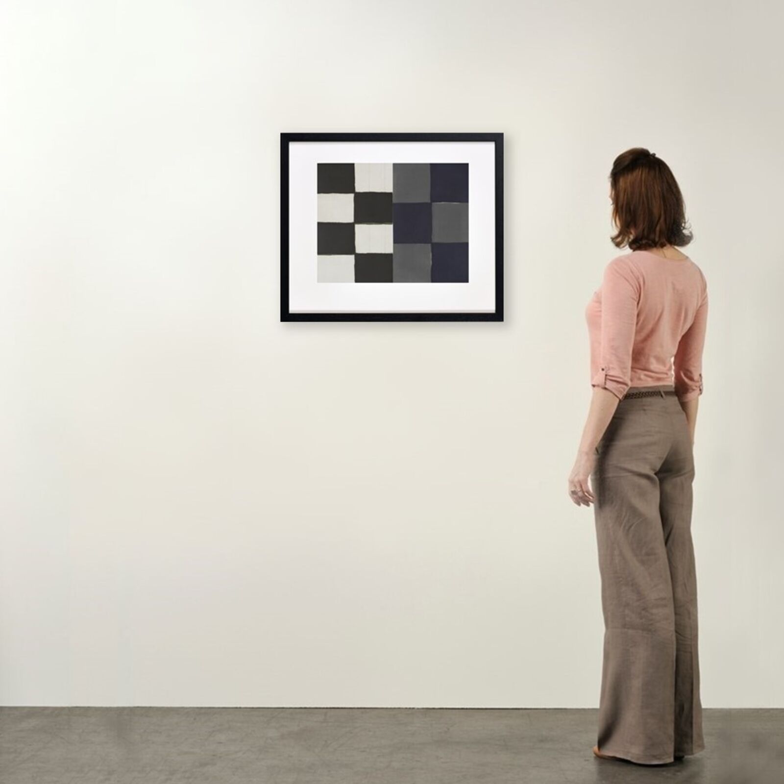 A black and white painting hanging on a wall.