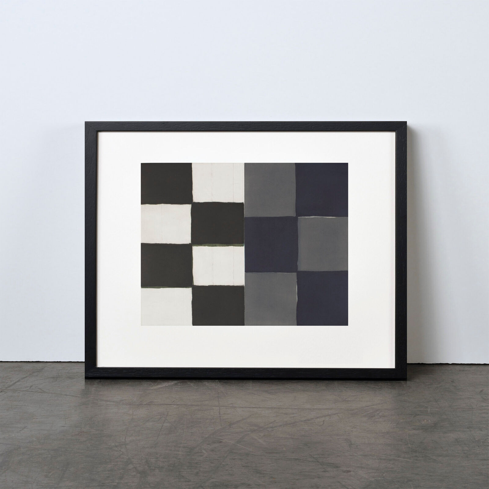 A black and white painting hanging on a wall.