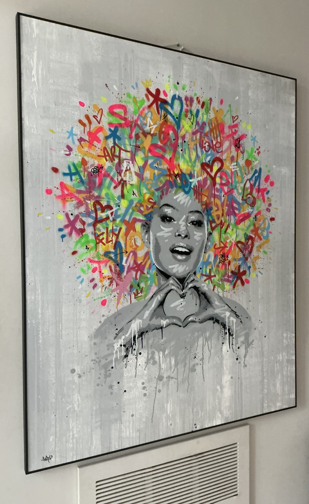 A portrait of a figure with a vibrant, graffiti-style explosion of colorful symbols and text erupting from their head.