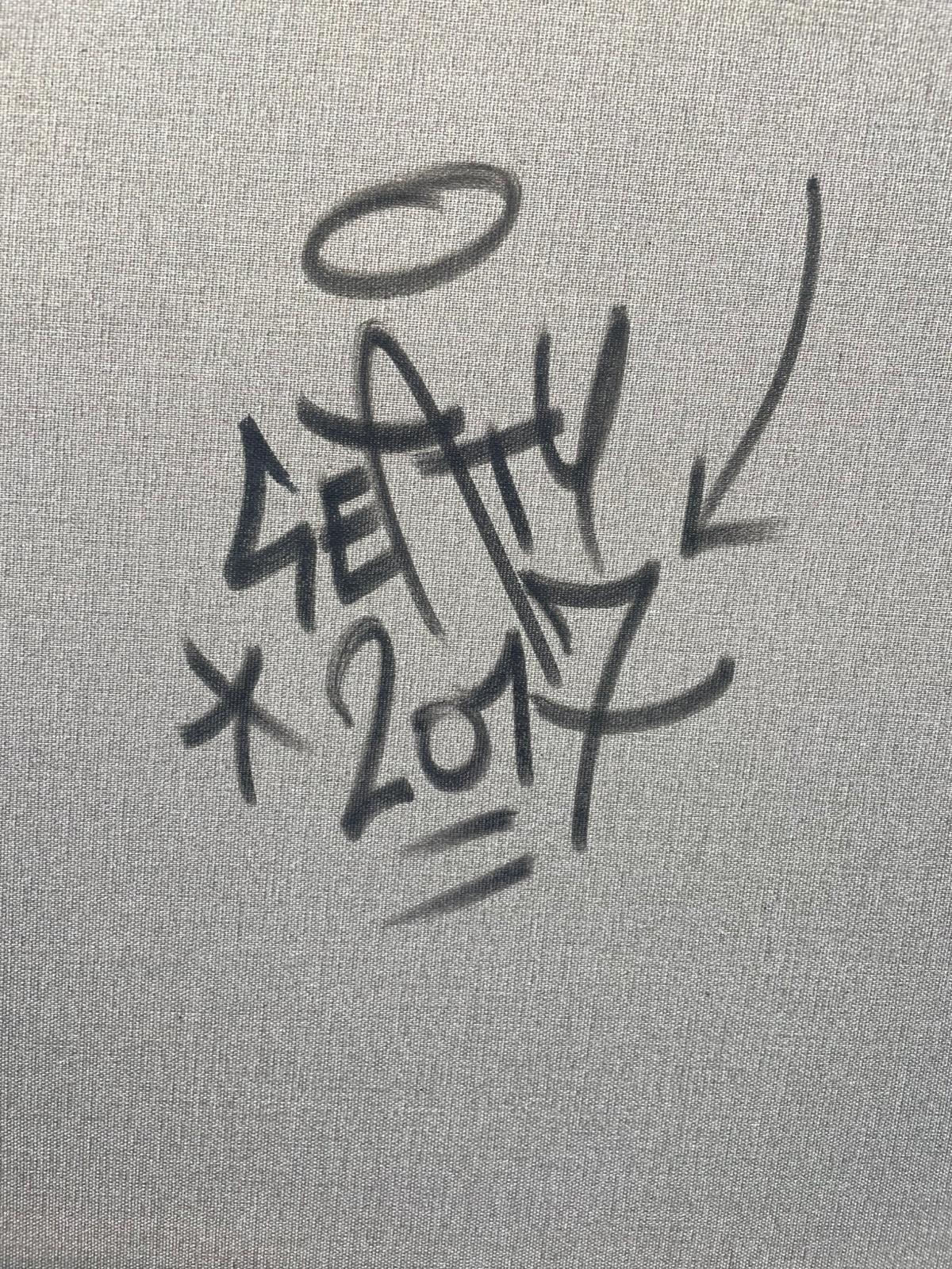 A portrait of a figure with a vibrant, graffiti-style explosion of colorful symbols and text erupting from their head.