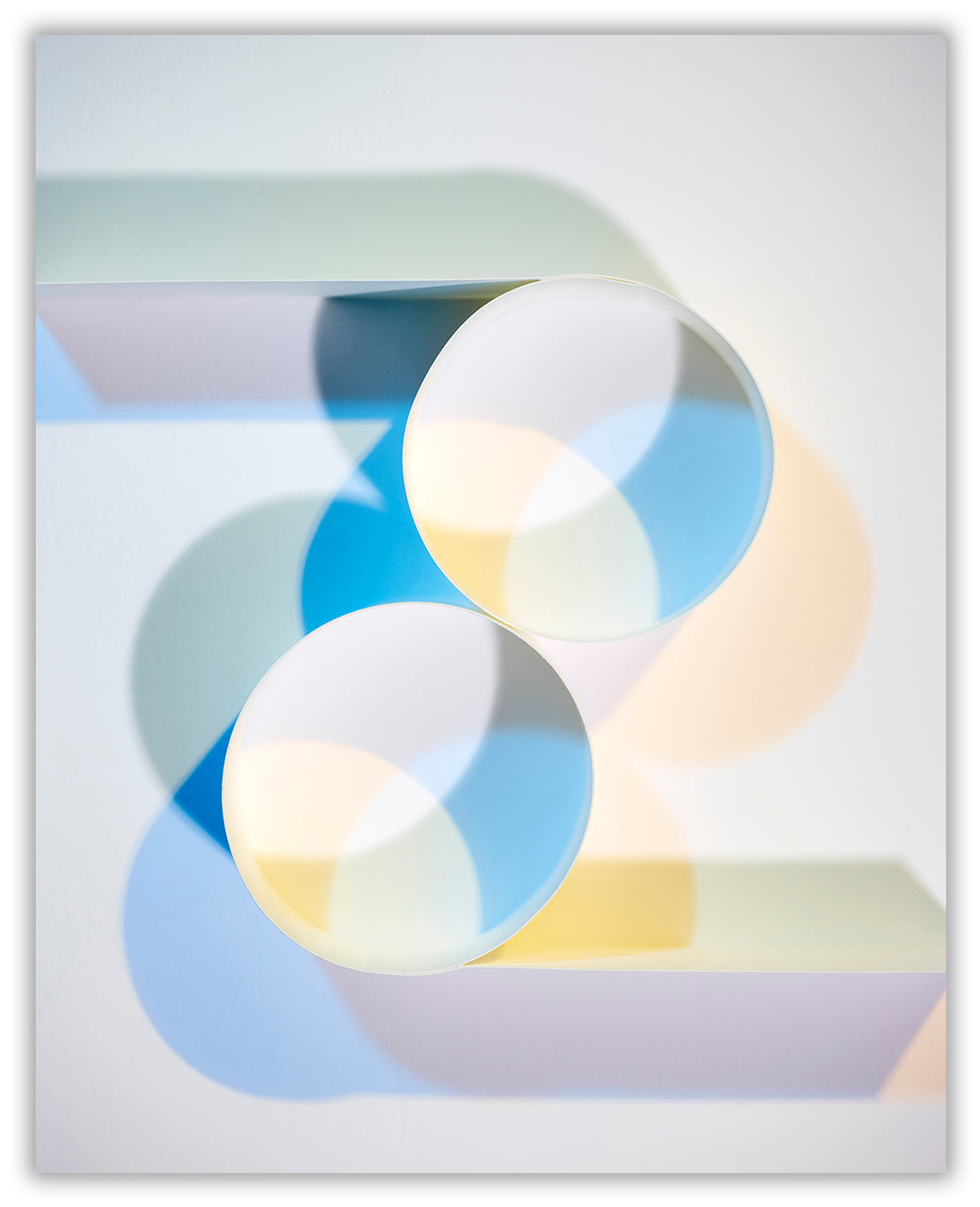 A picture of three circles on a white surface. 