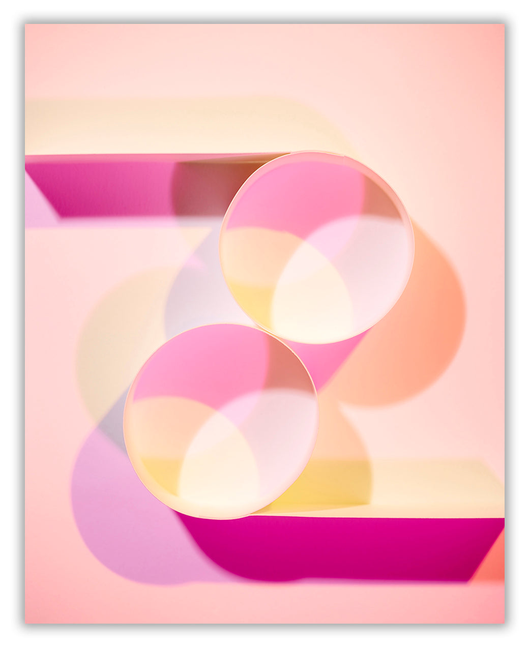 A pink and yellow abstract painting with circles on a pink background.
