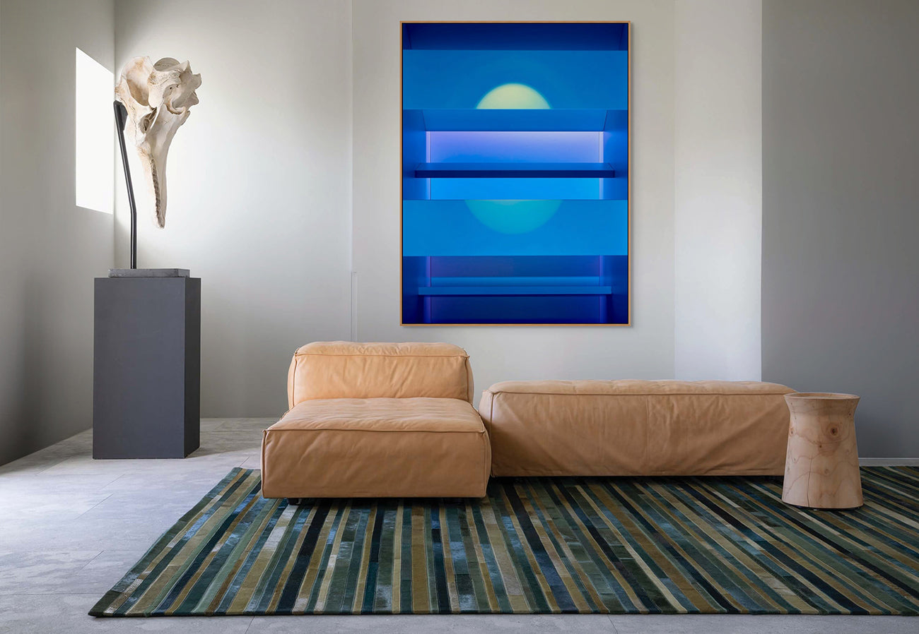 A blue wall with shelves and a blue light on it.