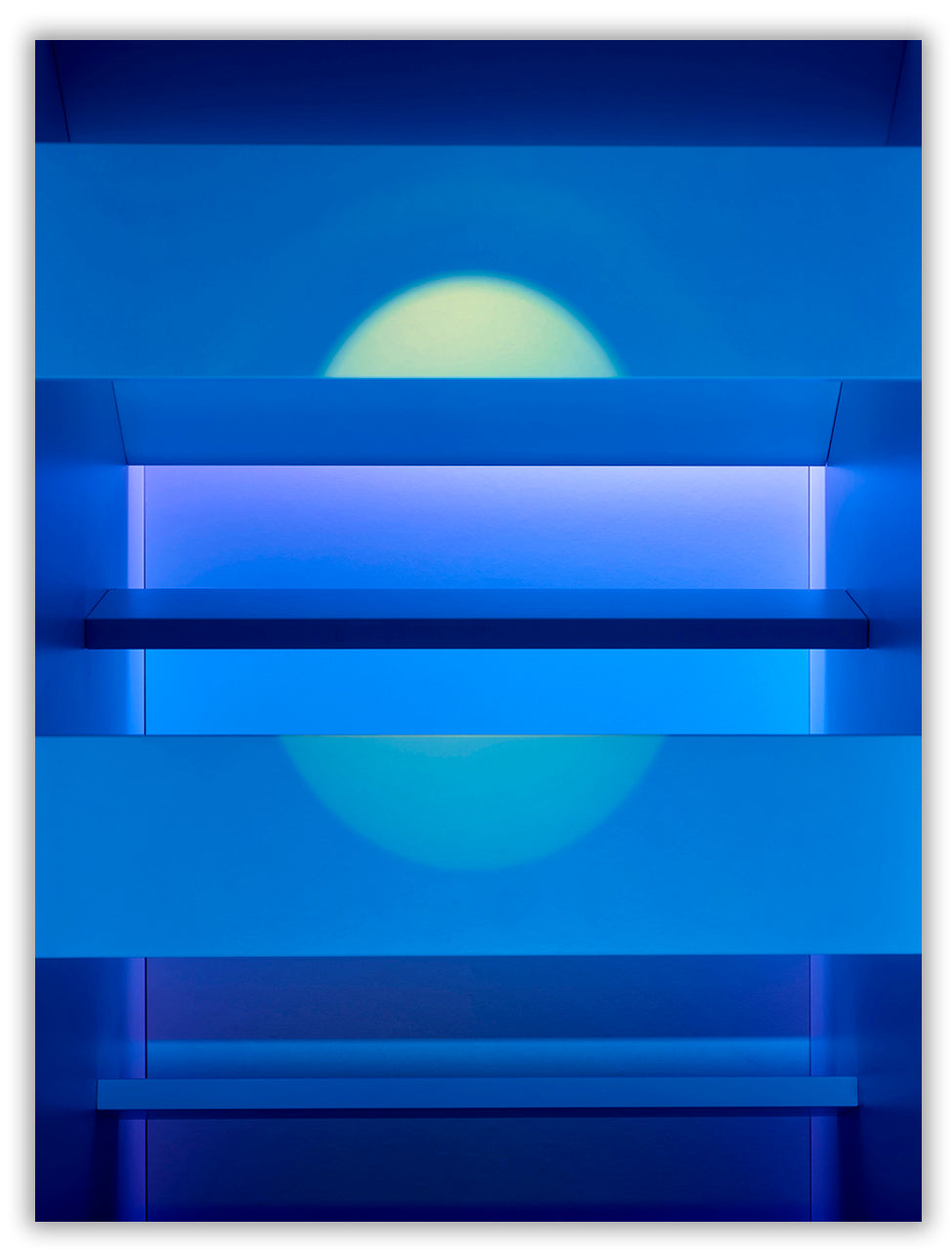A blue wall with shelves and a blue light on it.