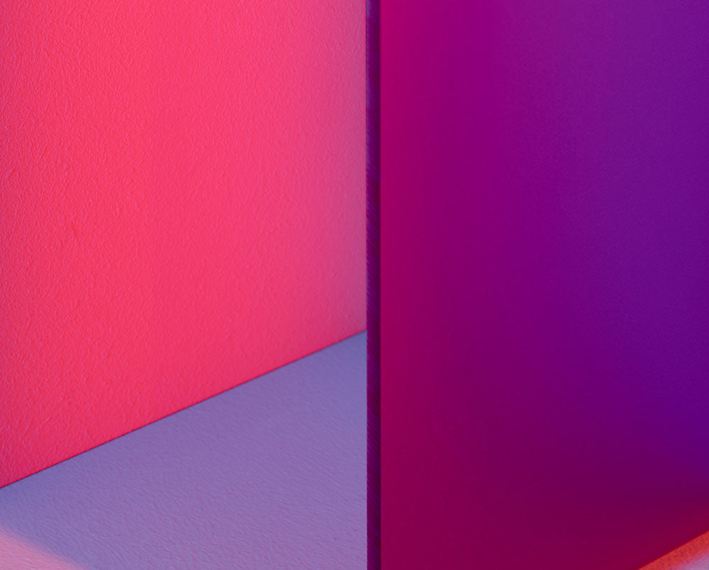 A picture of a pink and blue cube in a room.