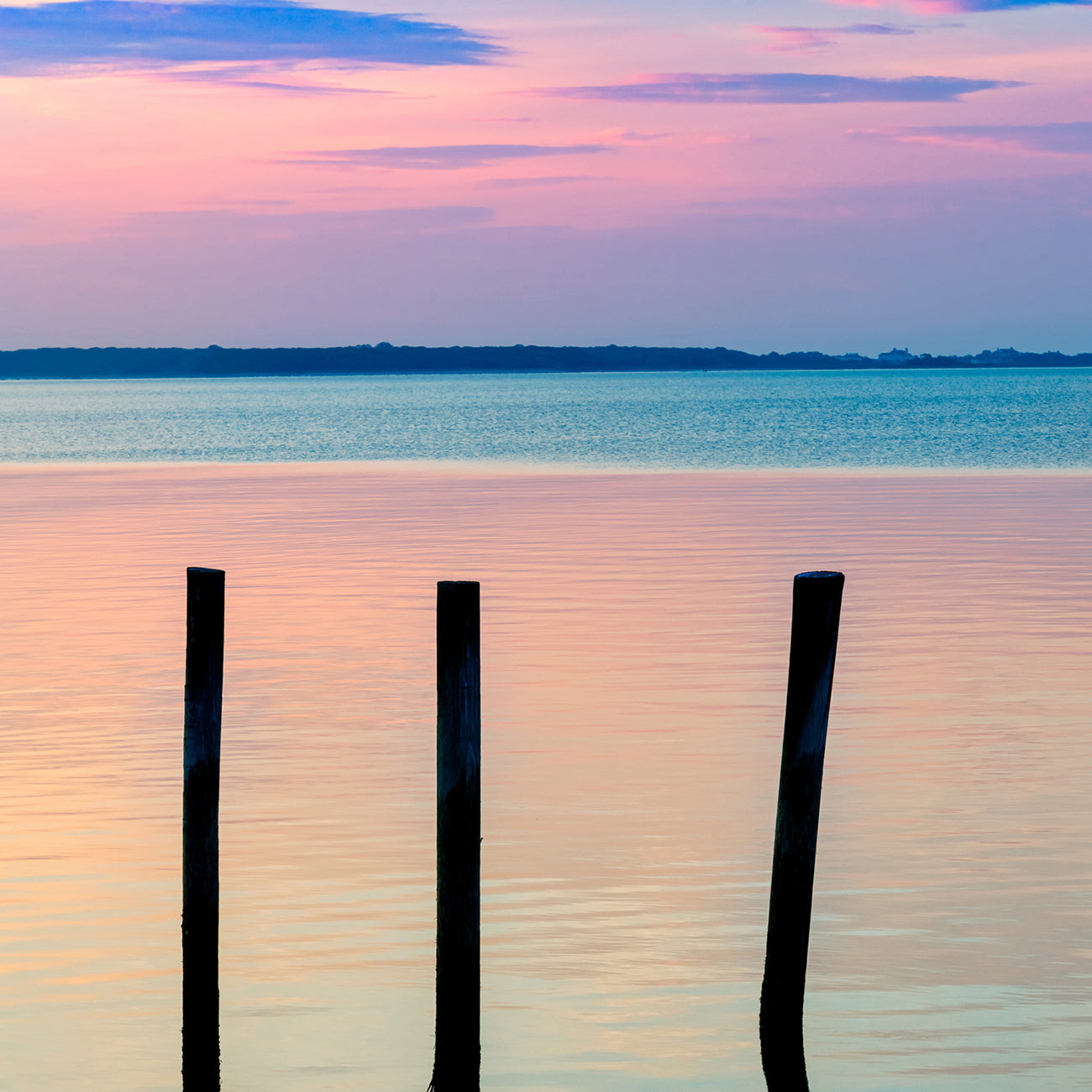 A picture of two pictures of a sunset over a body of water.