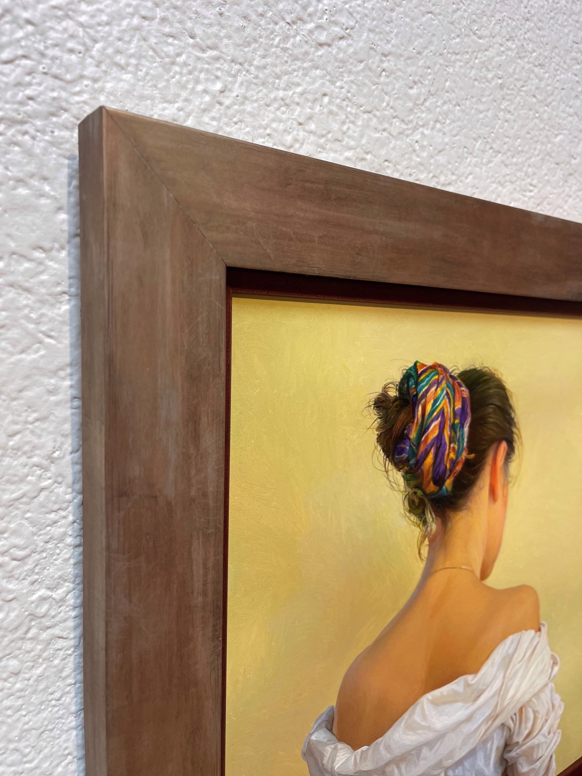 A painting of a woman with a colorful headband on her head.