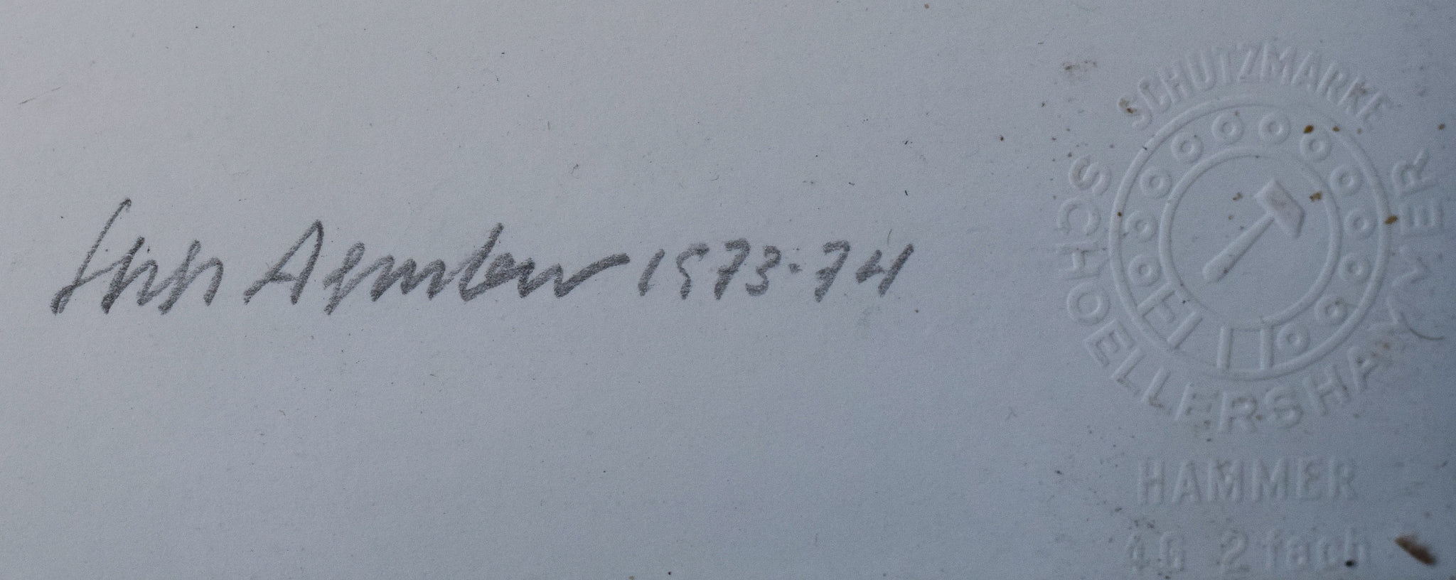 A black sculpture on a white wall in a room.