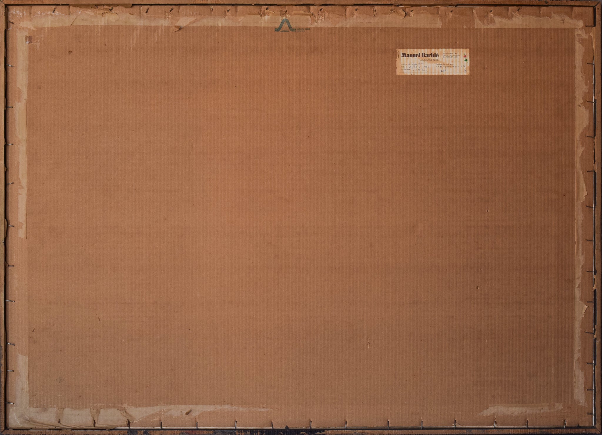 A black sculpture on a white wall in a room.