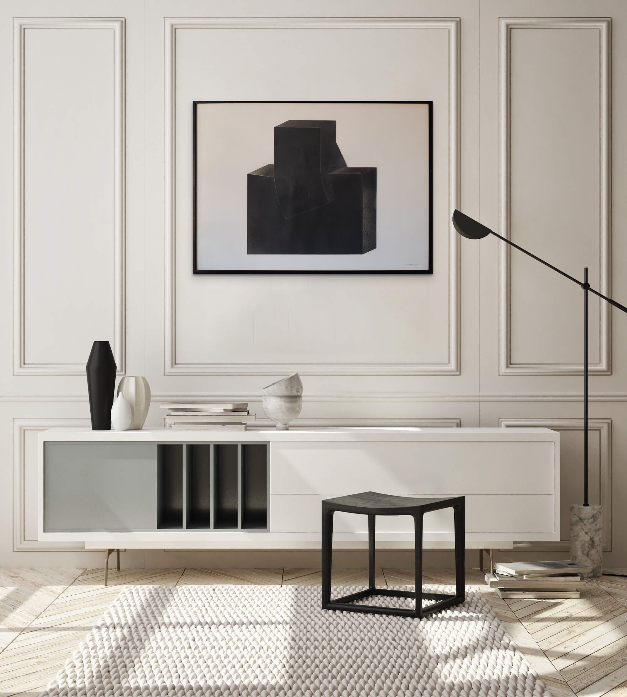 A black sculpture on a white wall in a room.