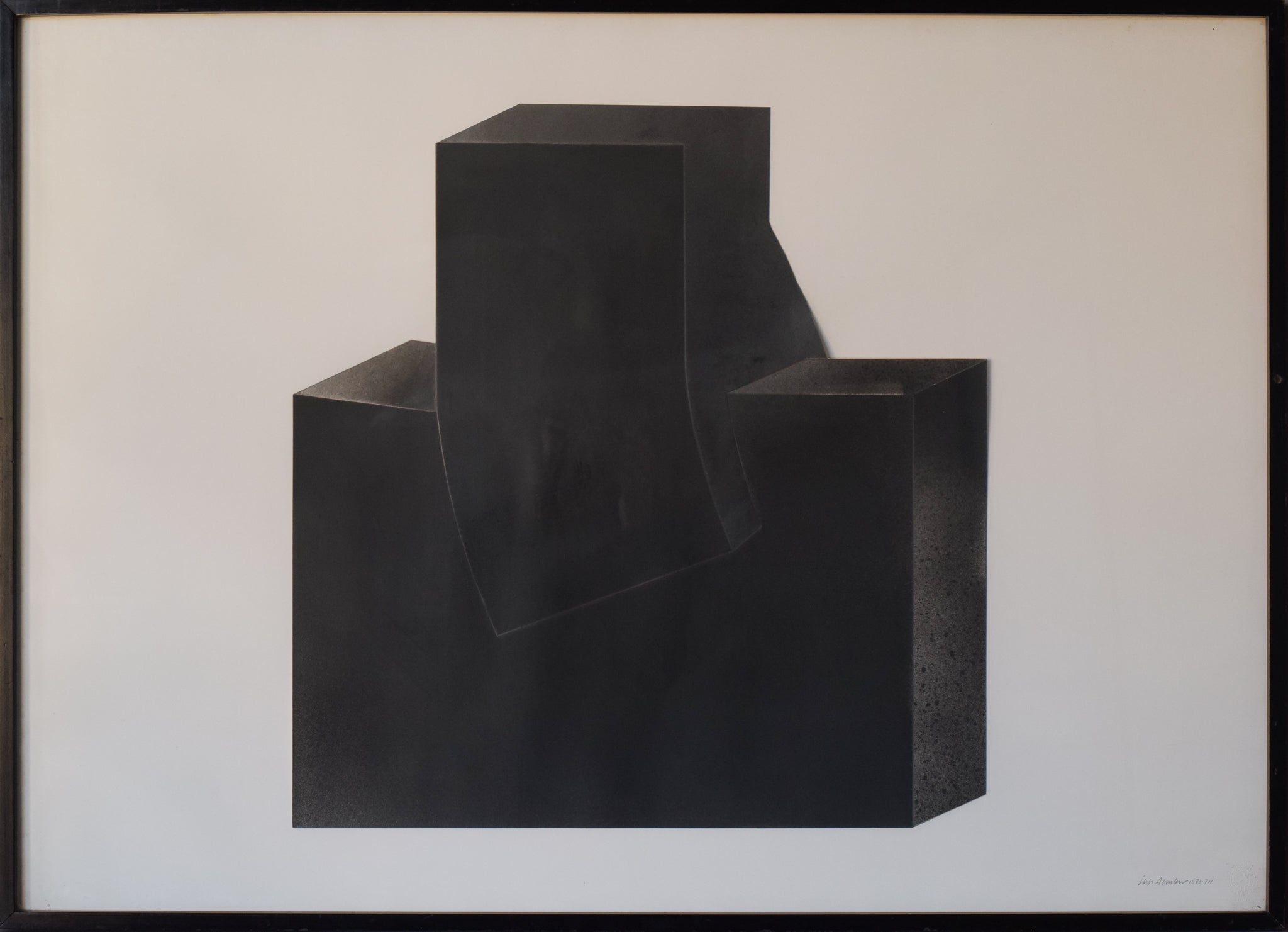 A black sculpture on a white wall in a room.