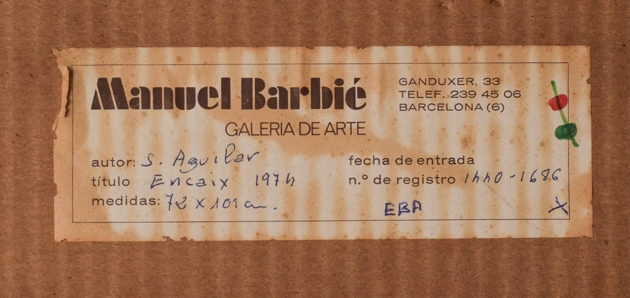 A black sculpture on a white wall in a room.