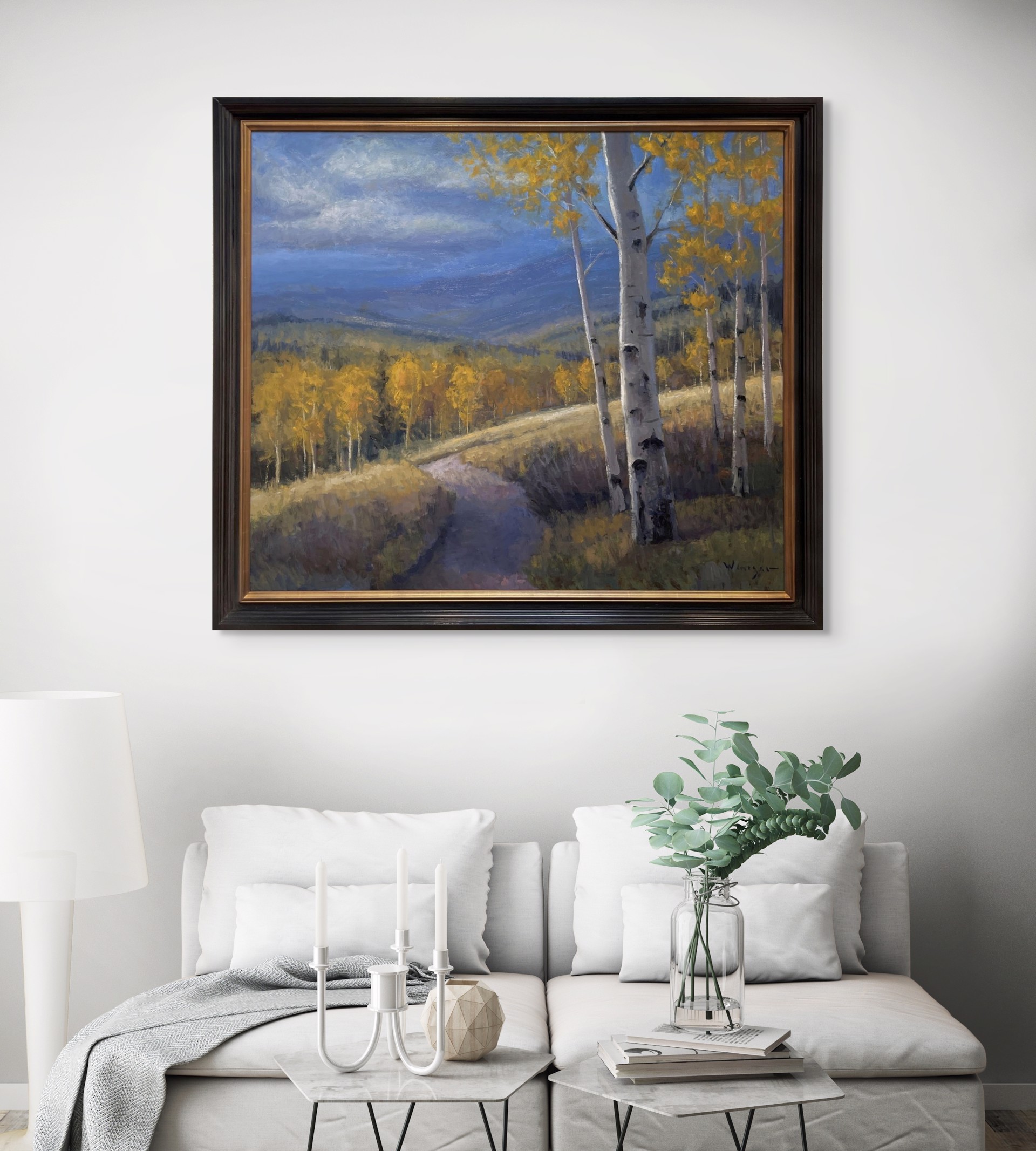 A serene autumn landscape featuring a winding path through golden aspen trees under a dramatic blue sky.