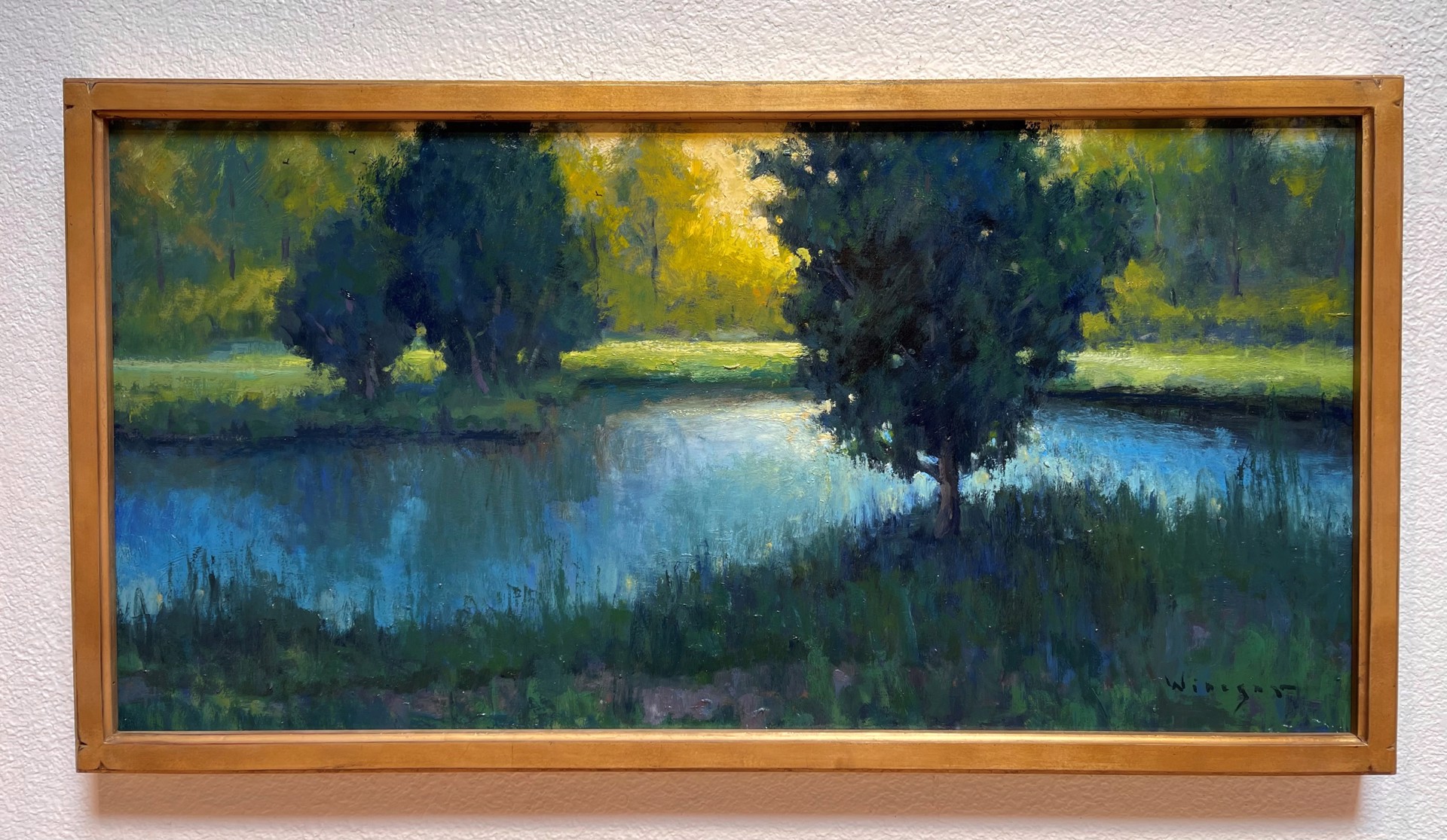A painting of a lake with trees in the background.