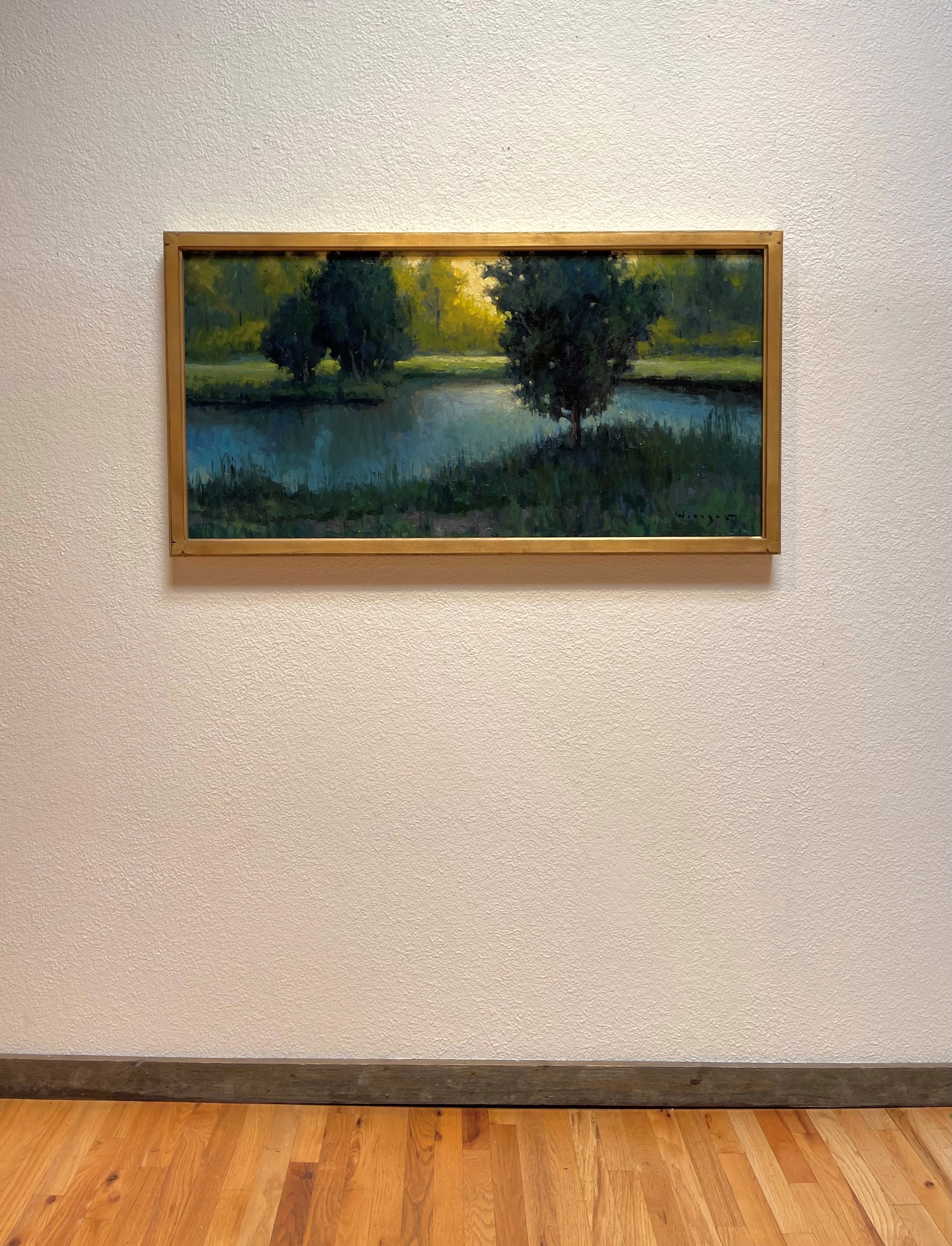 A painting of a lake with trees in the background.