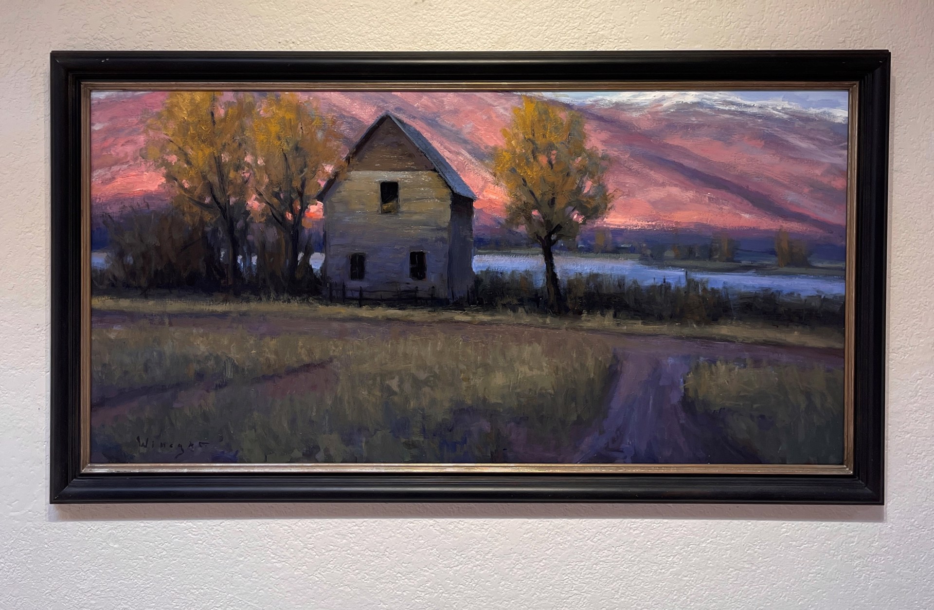 A painting of an old house in the middle of a field.