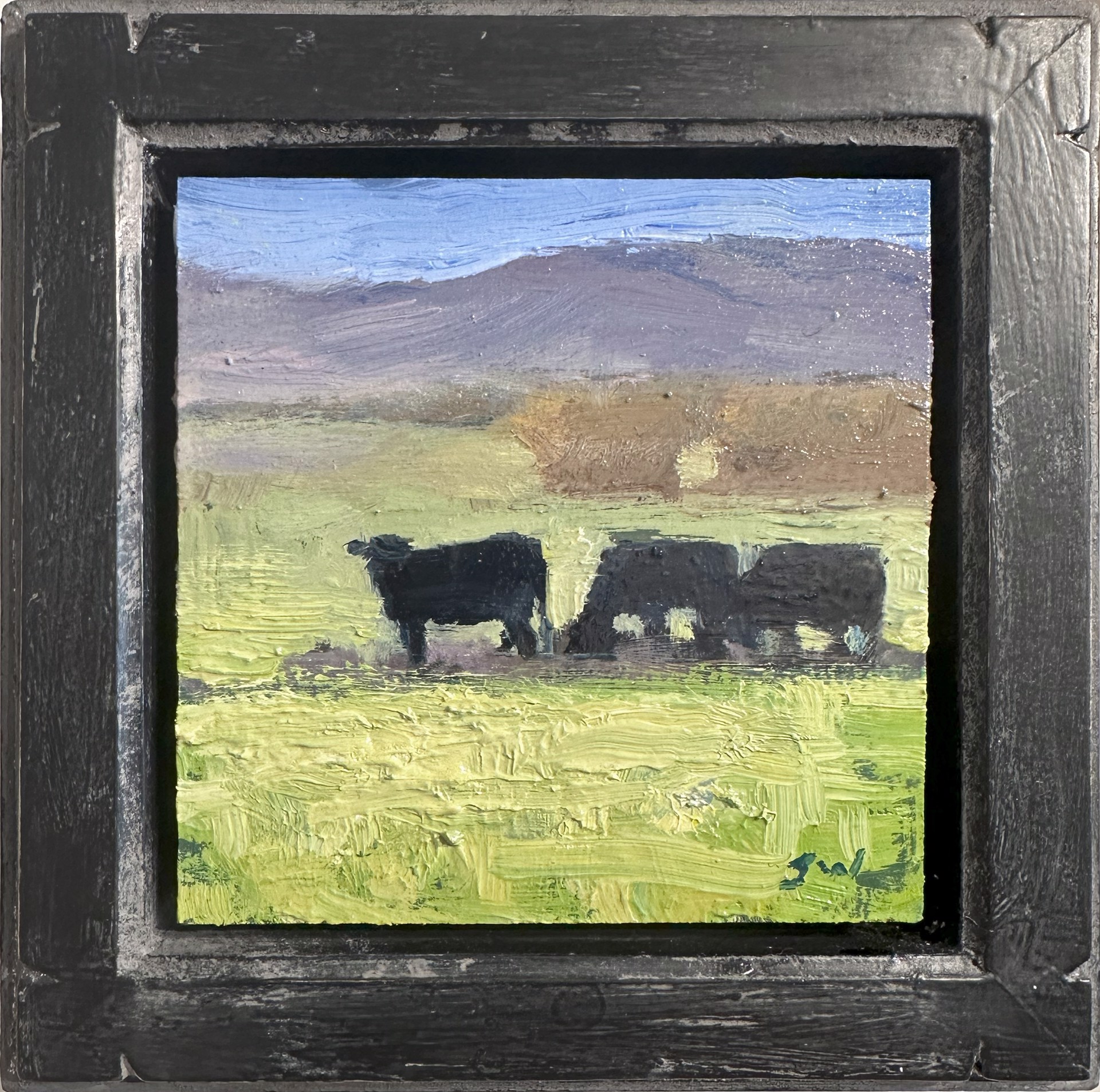 A painting of two cows grazing in a field.