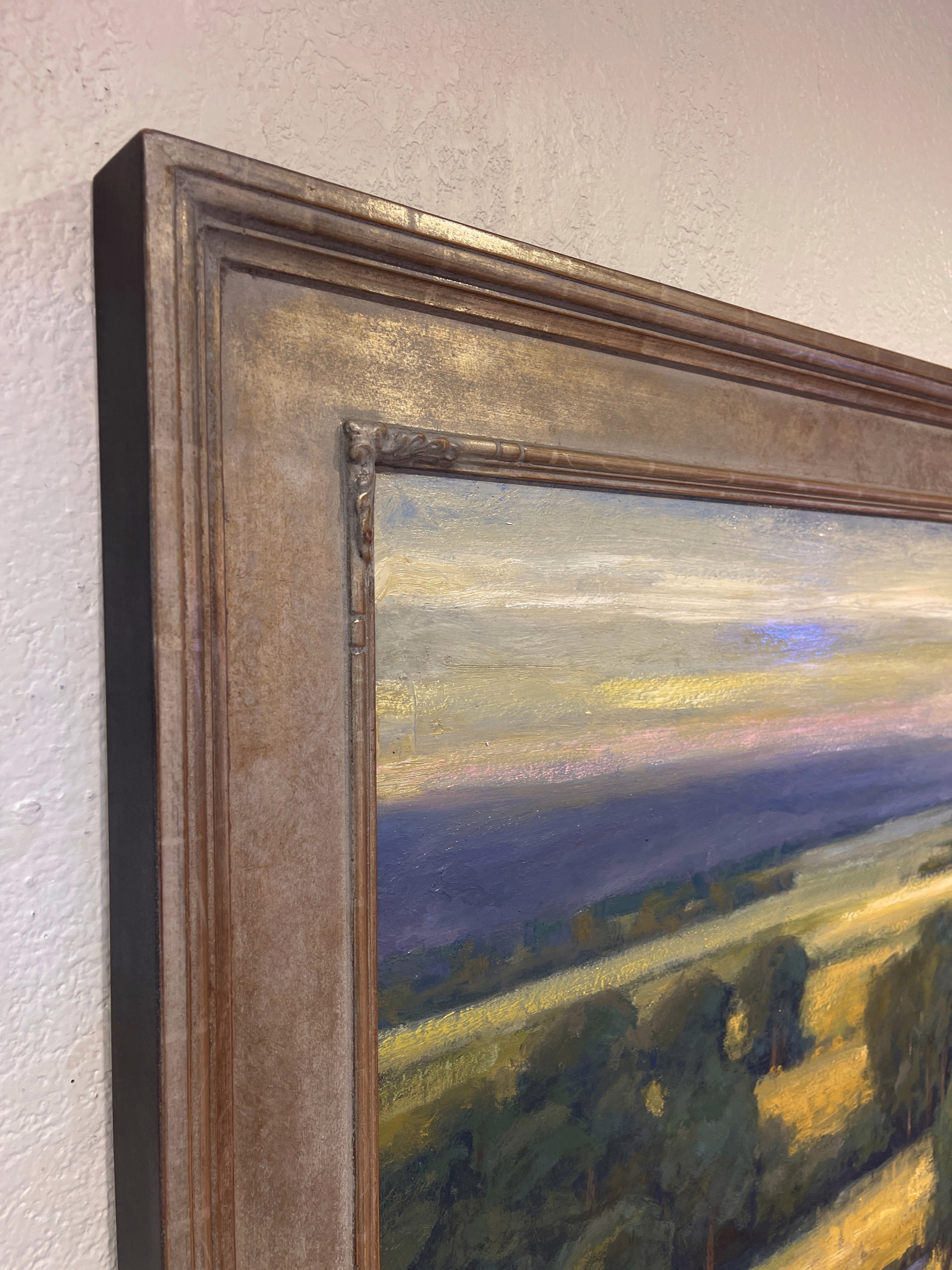 A painting of a field with trees in the distance.