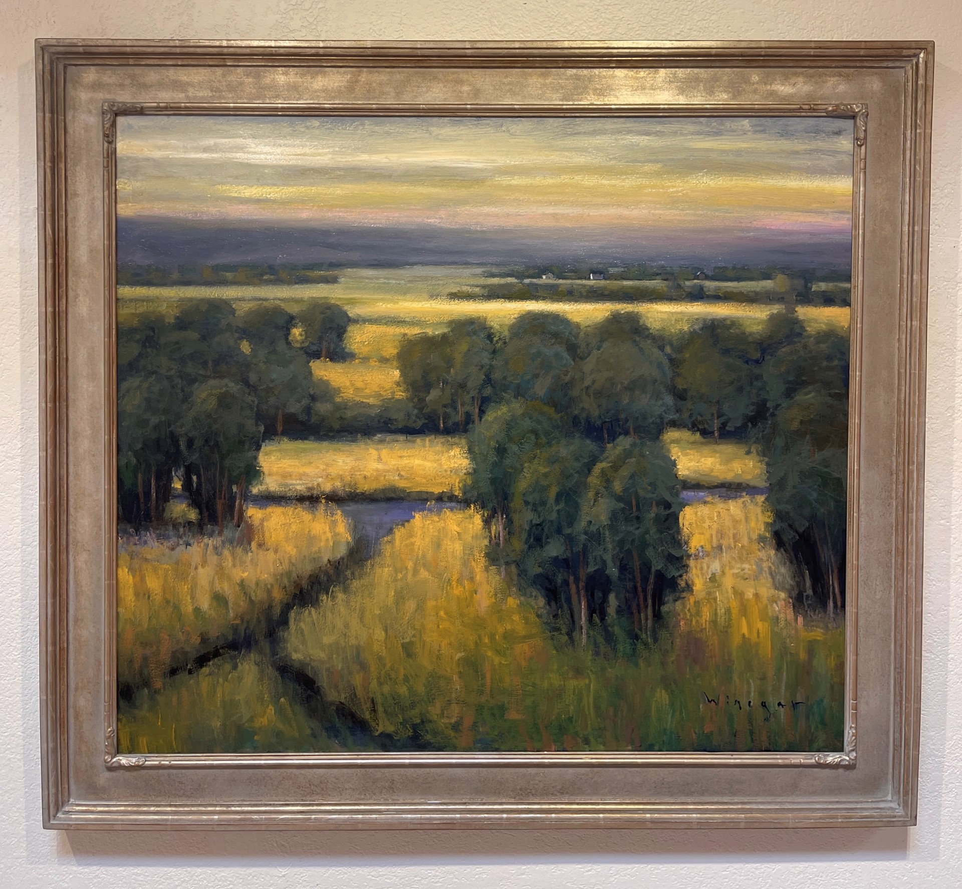 A painting of a field with trees in the distance.