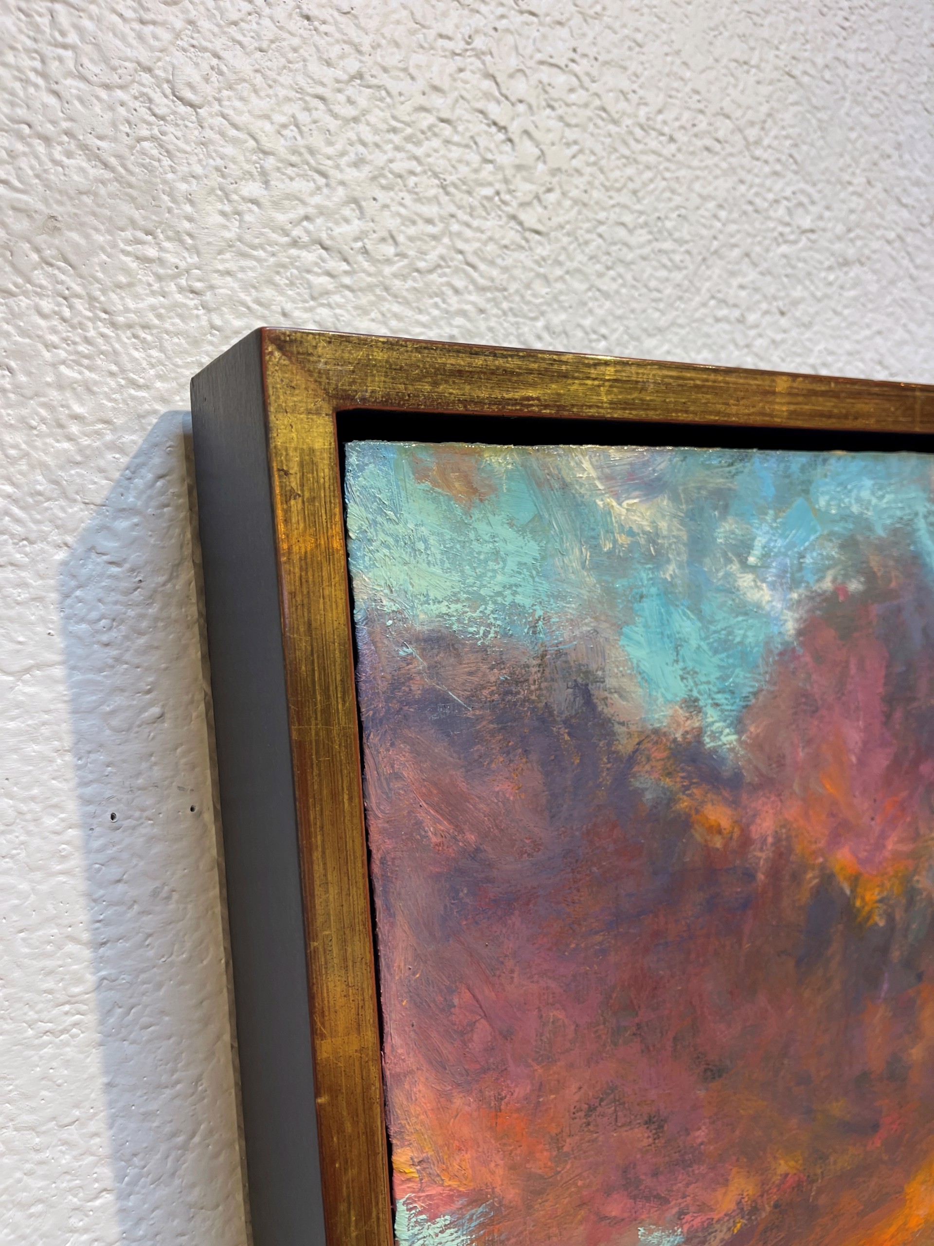 A painting of a sunset over a body of water.