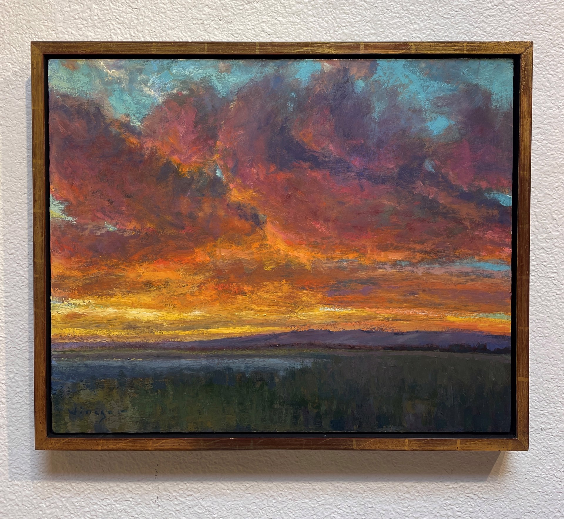A painting of a sunset over a body of water.