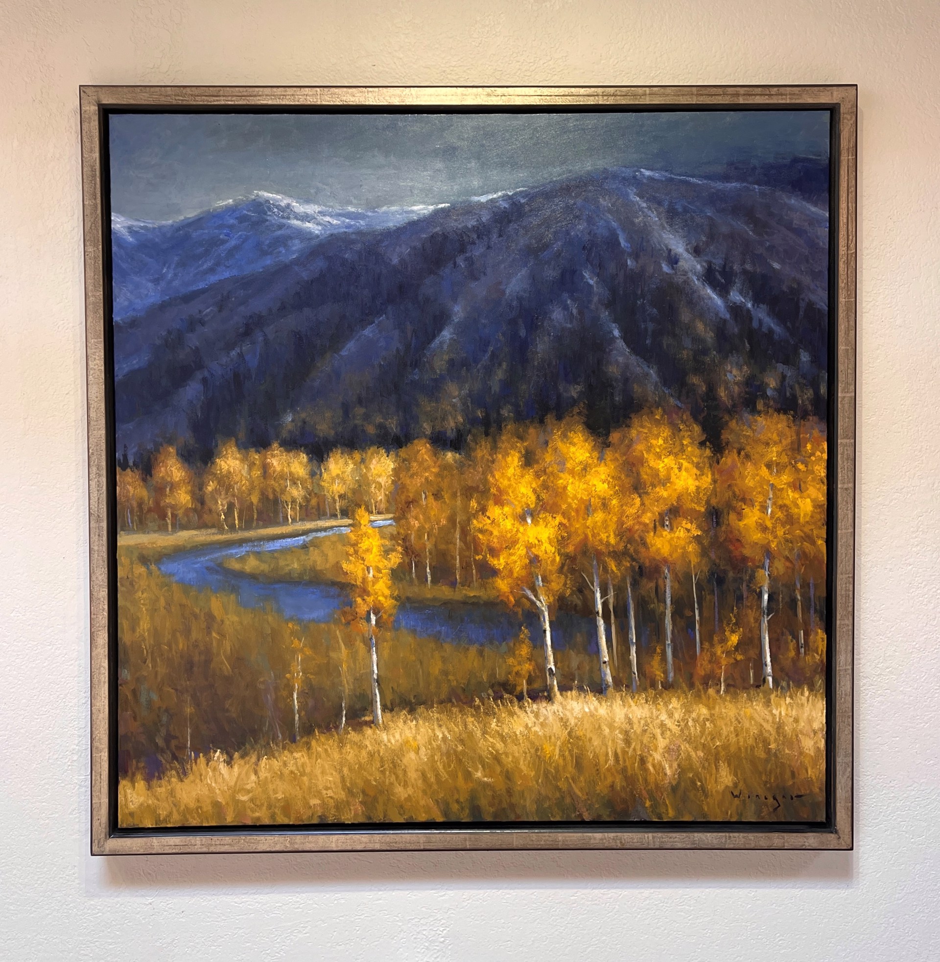 A vibrant autumn landscape painting featuring golden birch trees and a winding river against dark mountains.