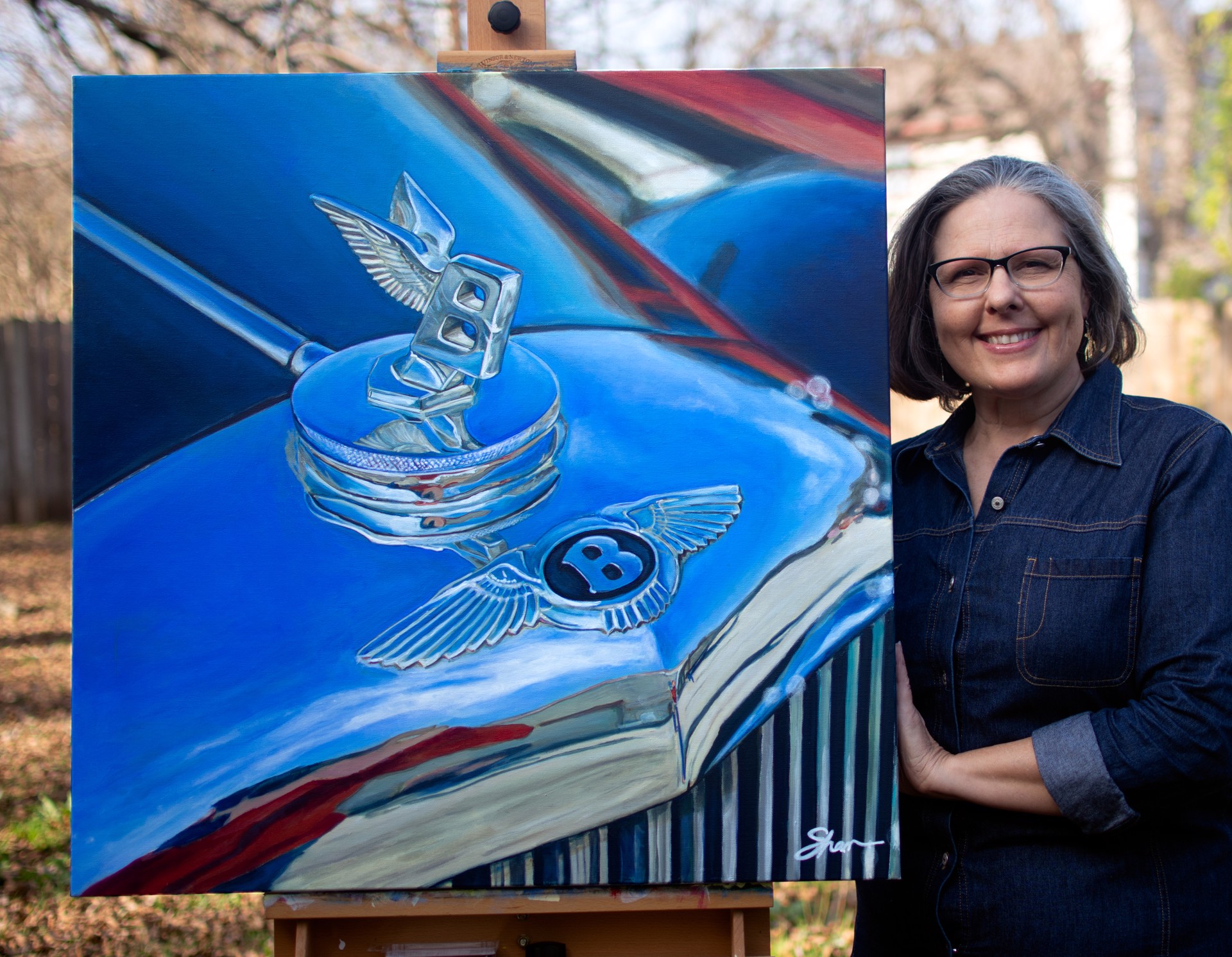 A painting of a blue car with a bentley logo on it.