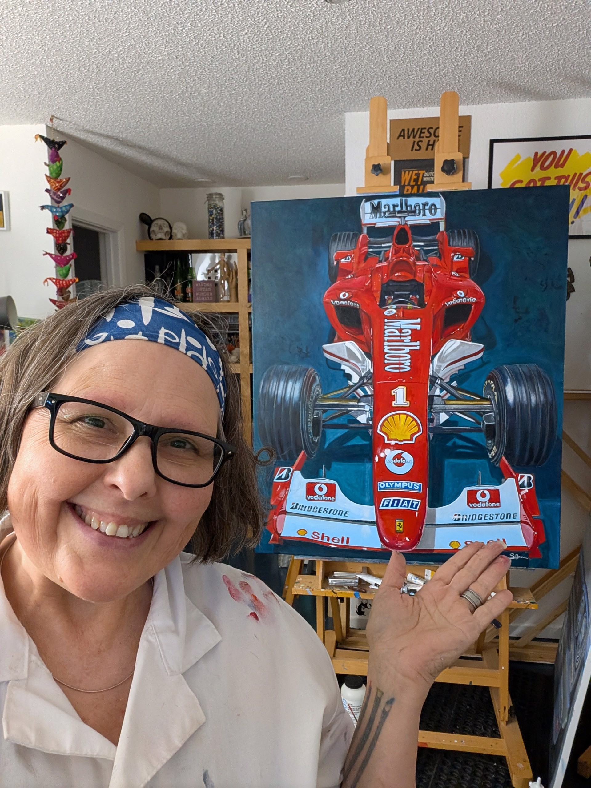 A detailed painting of a Formula One race car viewed from the front.