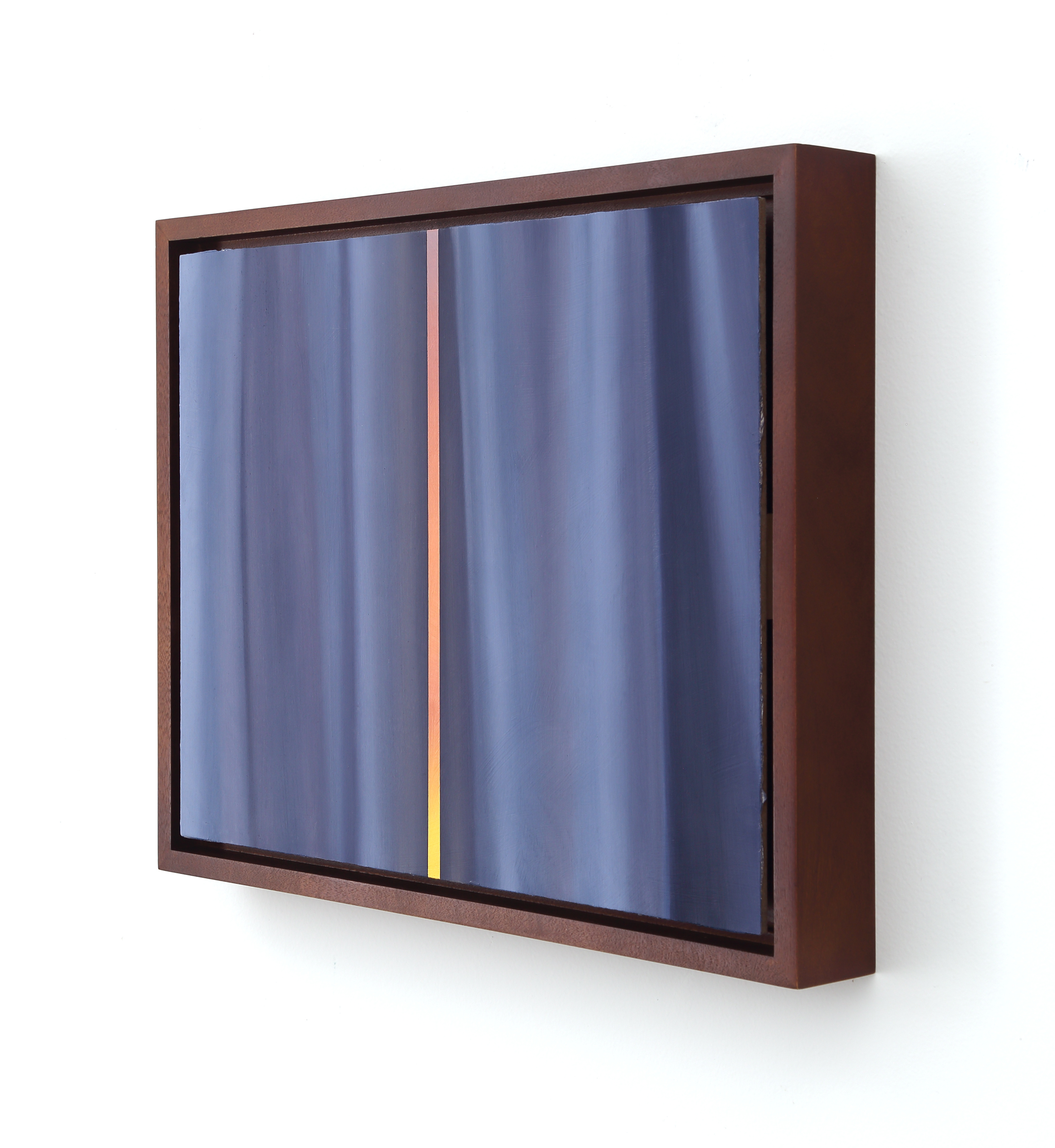 A picture of a window with a blue curtain in it.
