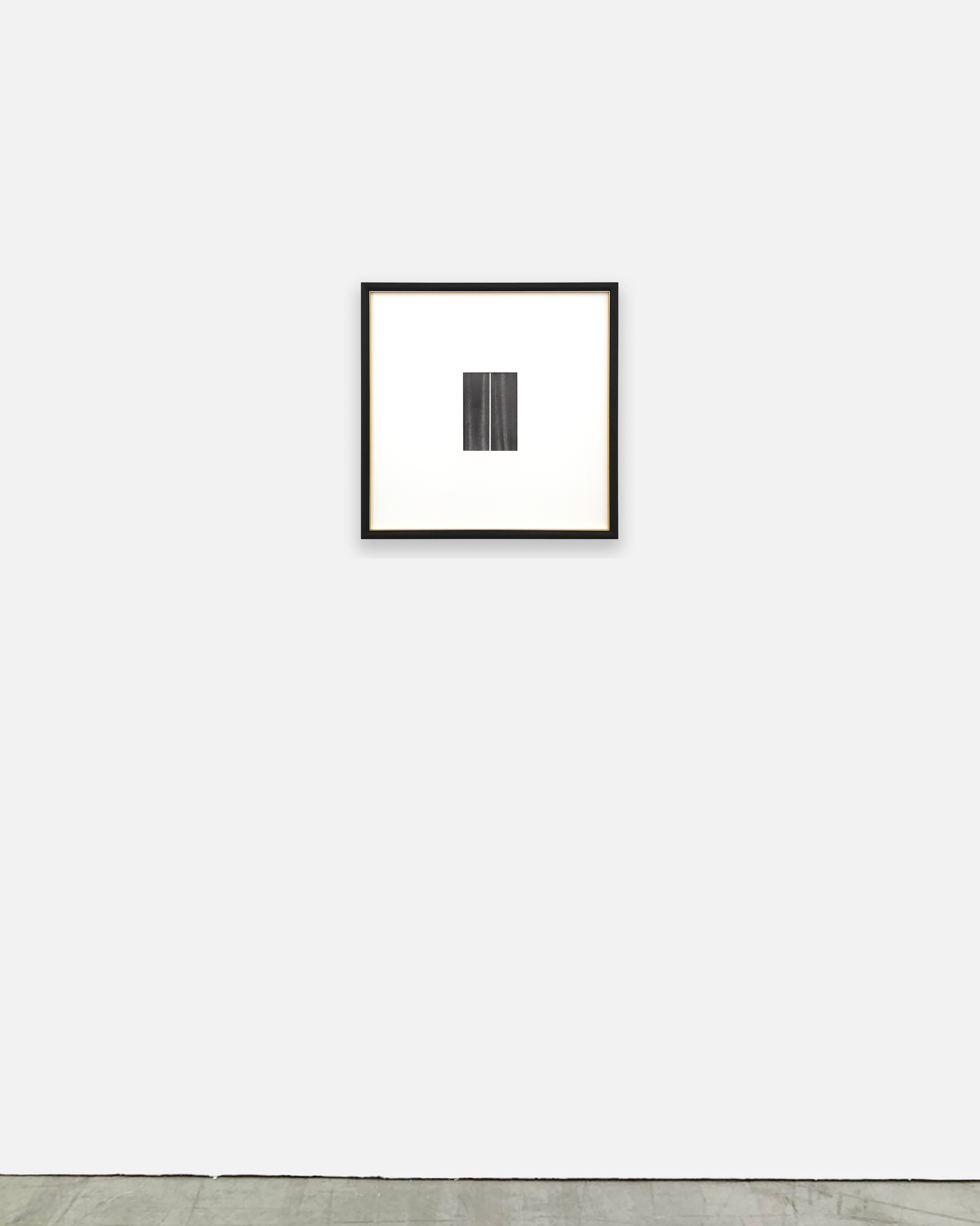 A black and white photo of a black frame on a white wall.