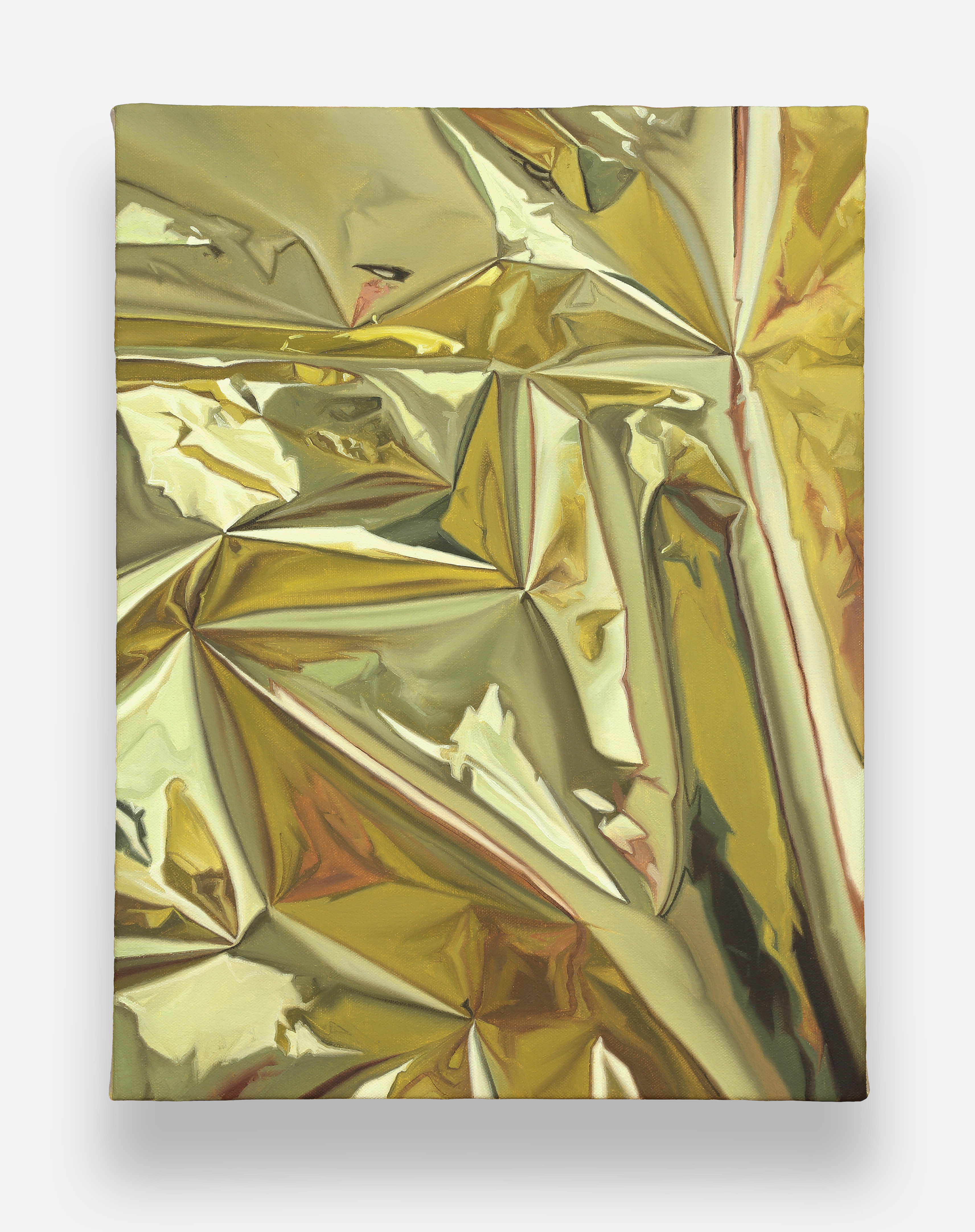 a close up of a piece of gold foil on a white background