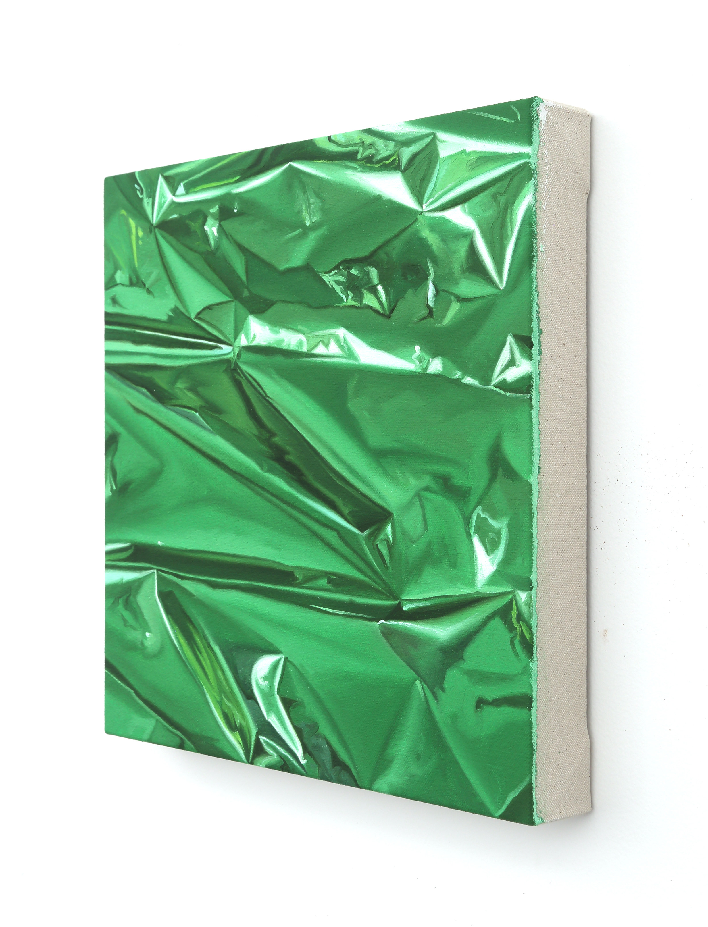 a close up of a green crumpled paper on a white background