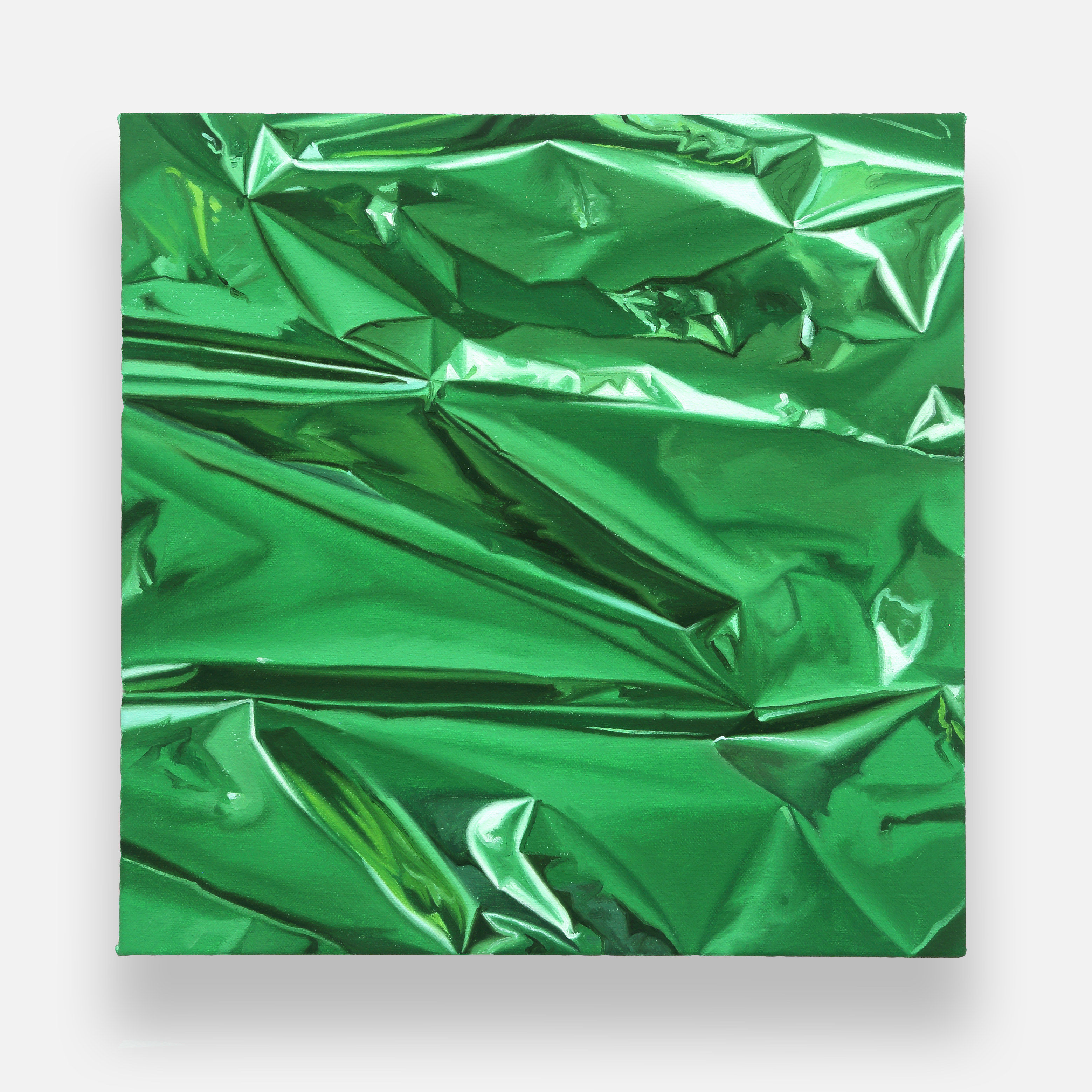 a close up of a green crumpled paper on a white background