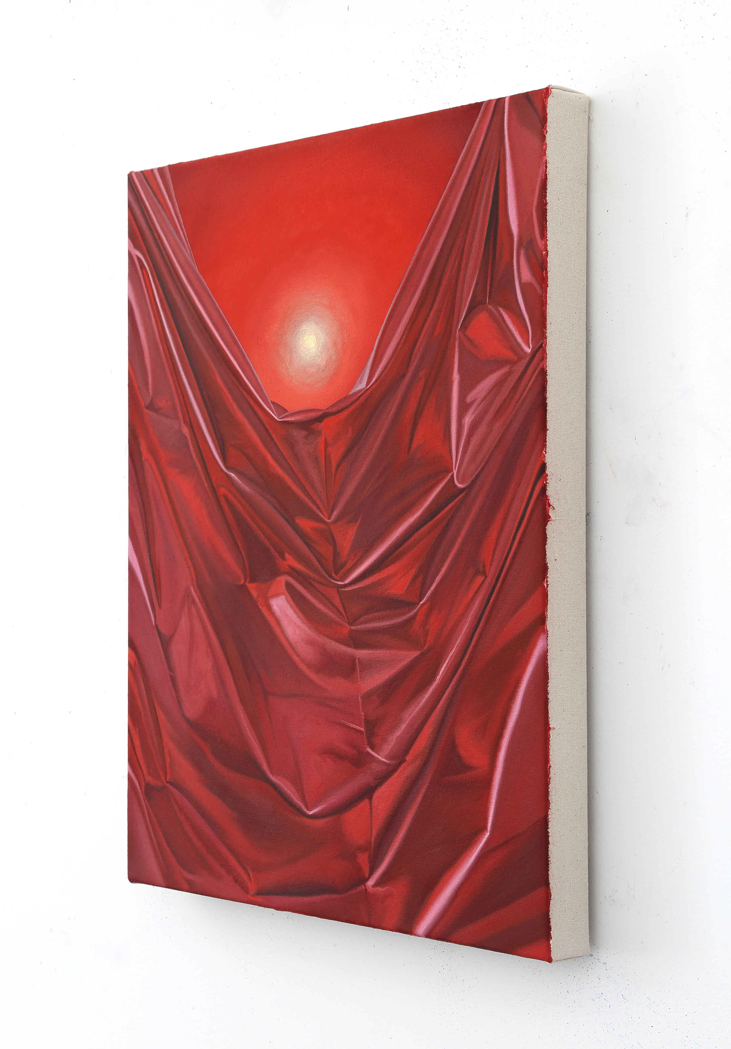 A painting of a red cloth with a sun in the background.