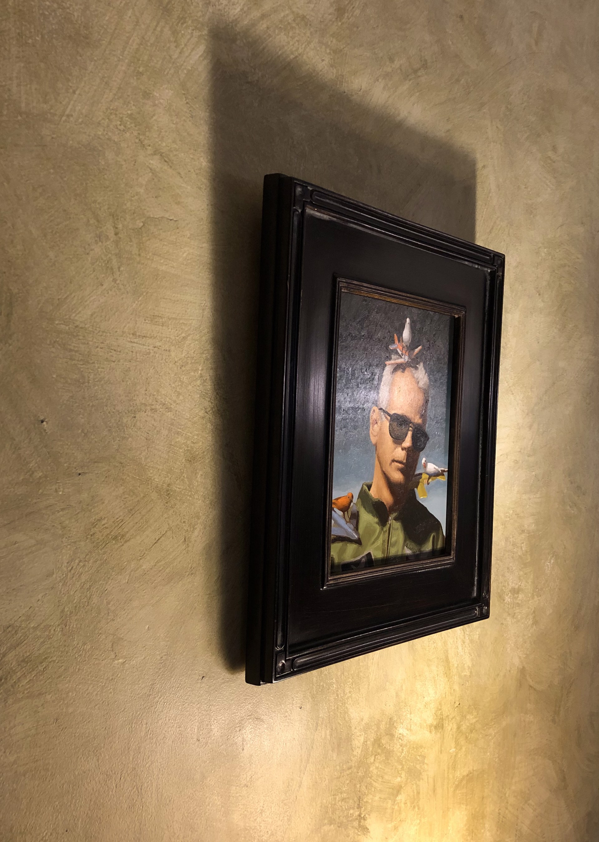 A painting of a man with birds on his head.