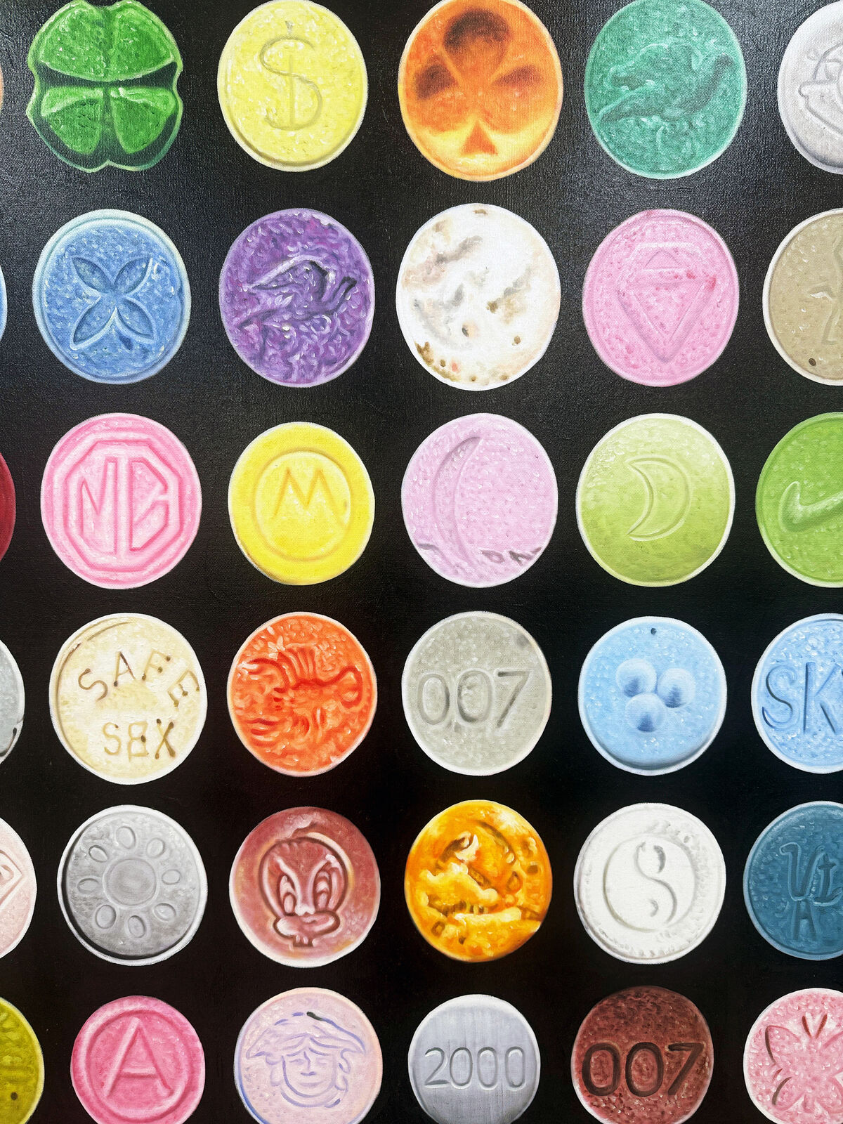A grid of colorful, embossed circular objects arranged on a black background.
