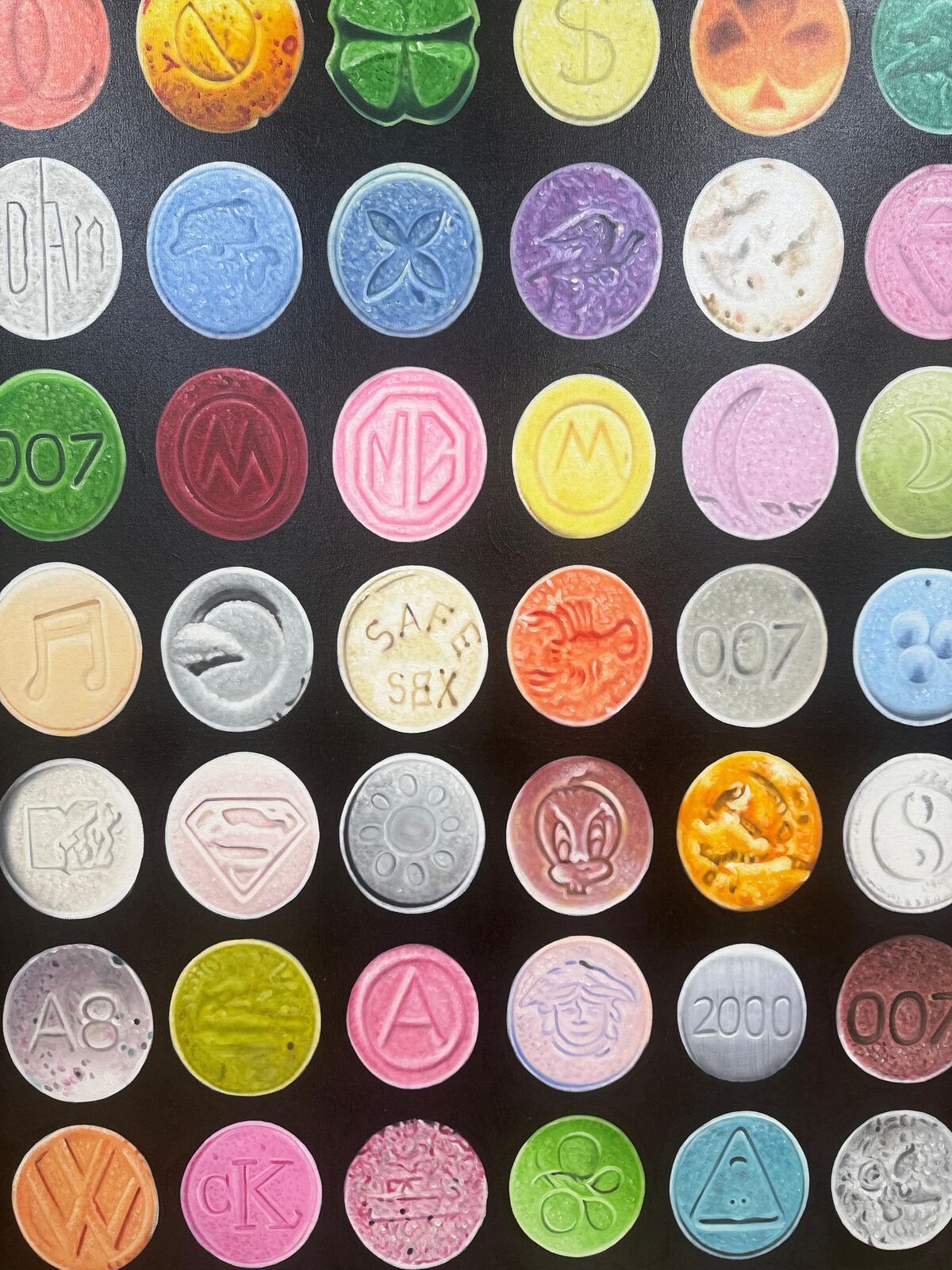 A grid of colorful, embossed circular objects arranged on a black background.
