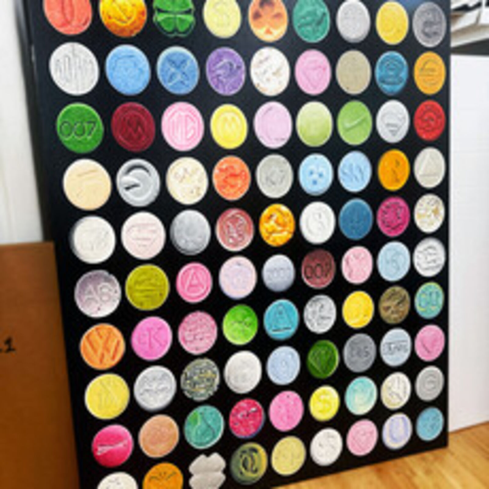 A grid of colorful, embossed circular objects arranged on a black background.