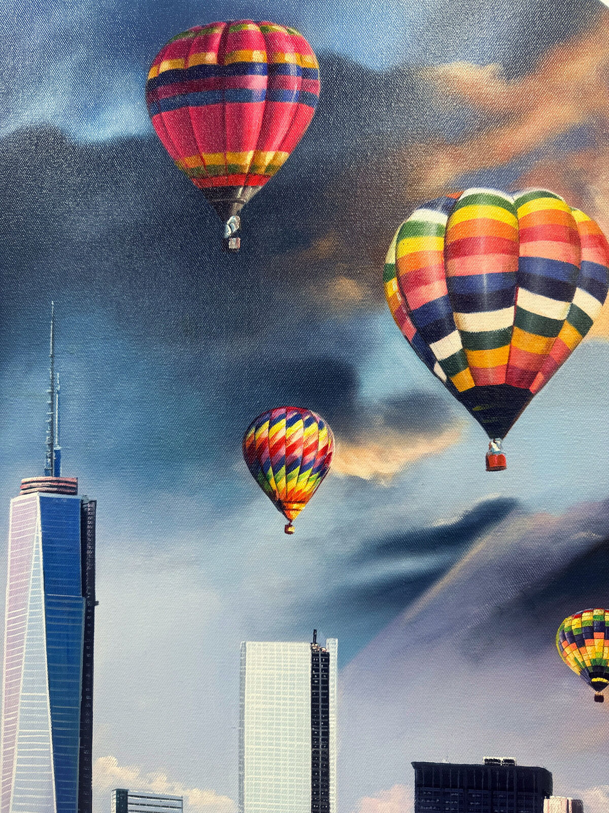 A picture of hot air balloons flying over a city.