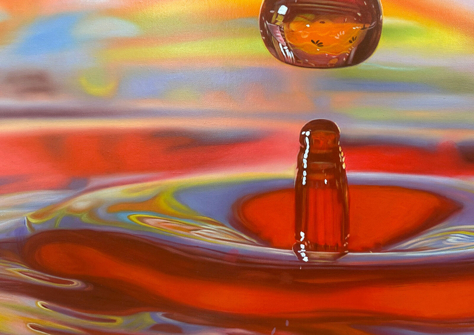 A drop of water falling into a pool of water.