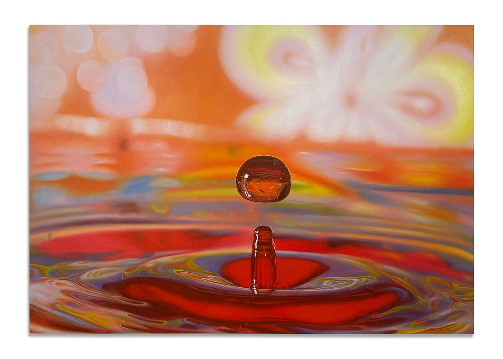 A drop of water falling into a pool of water.