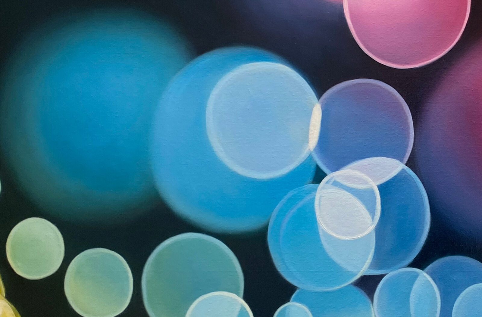 A picture of colorful circles on a black background.