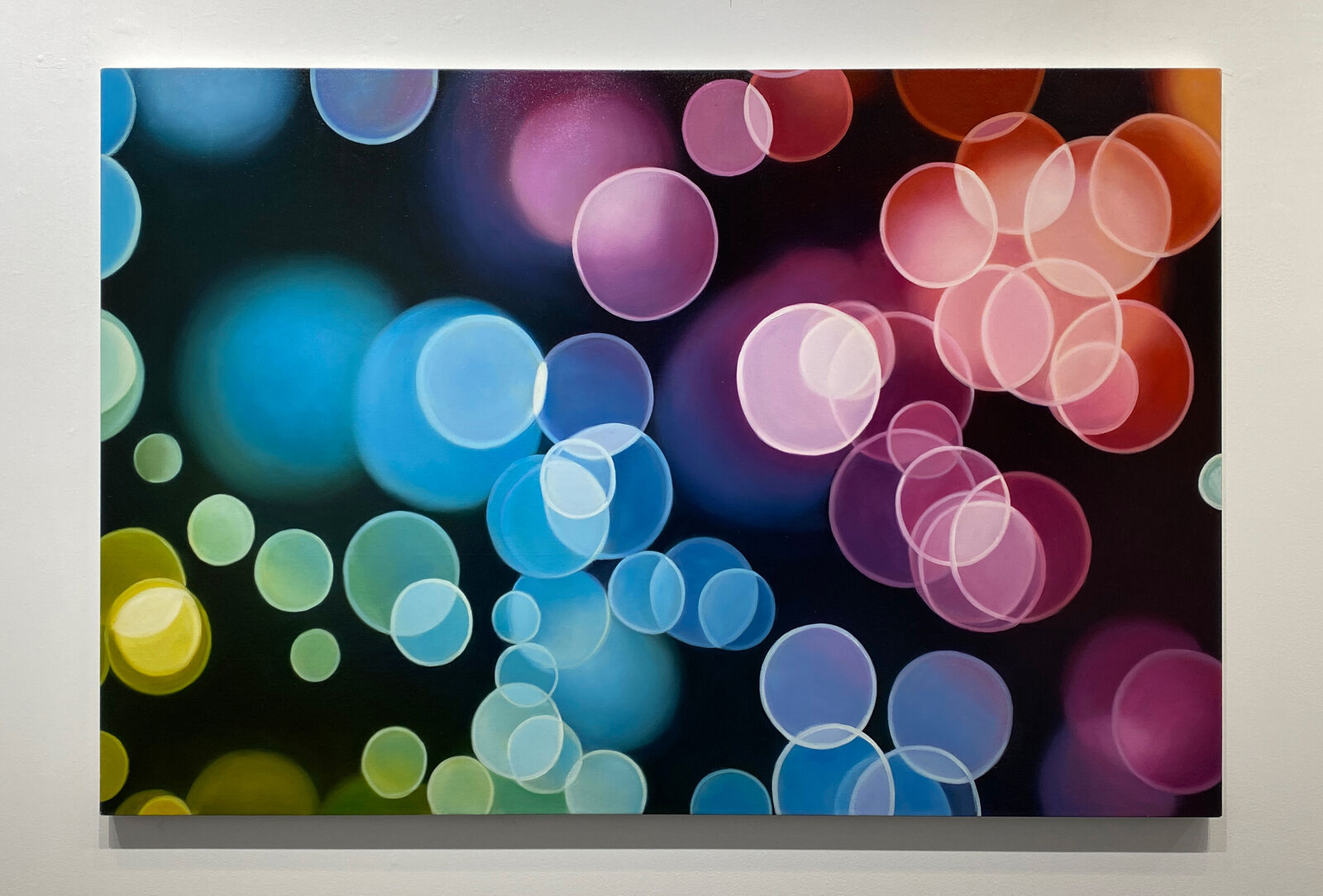 A picture of colorful circles on a black background.