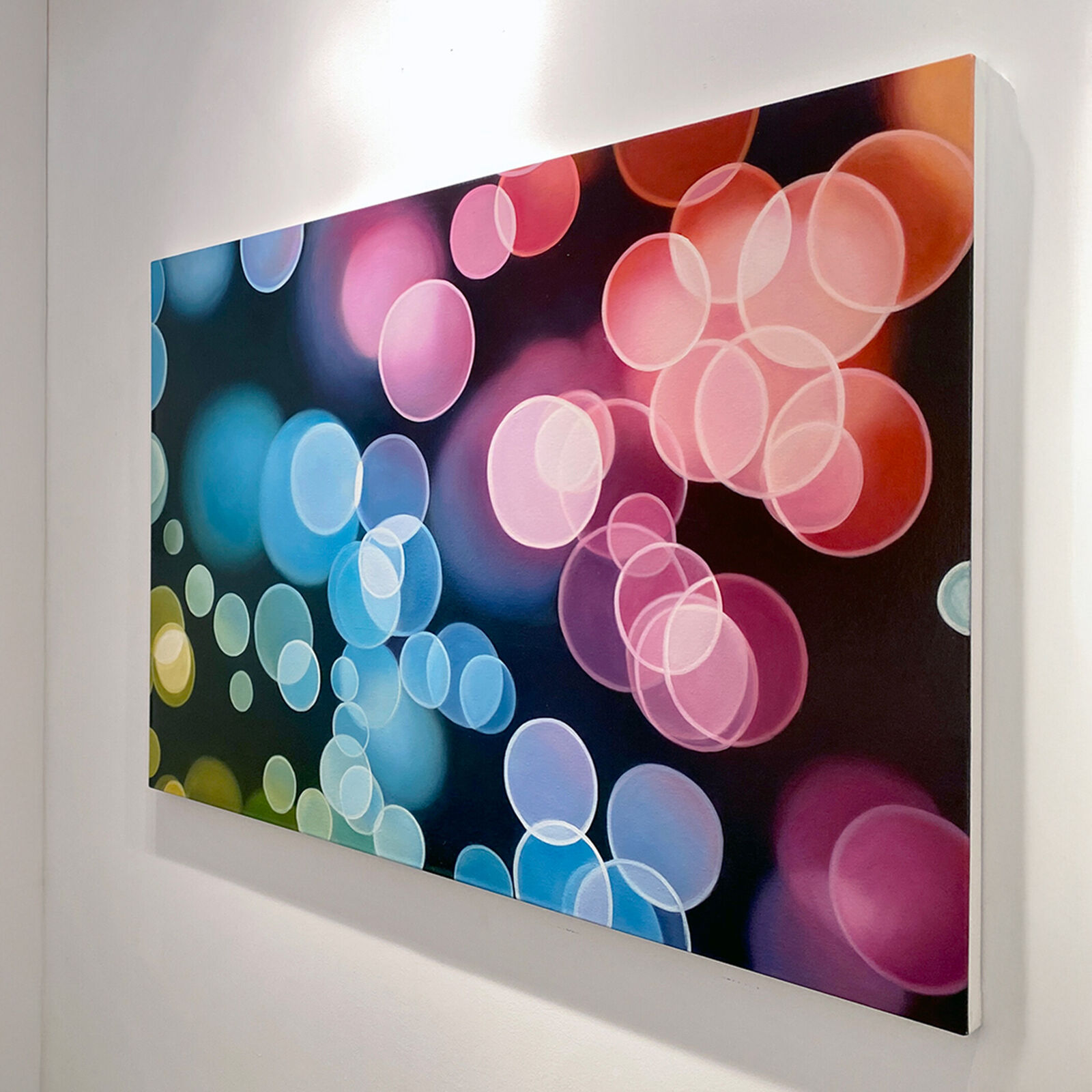 A picture of colorful circles on a black background.