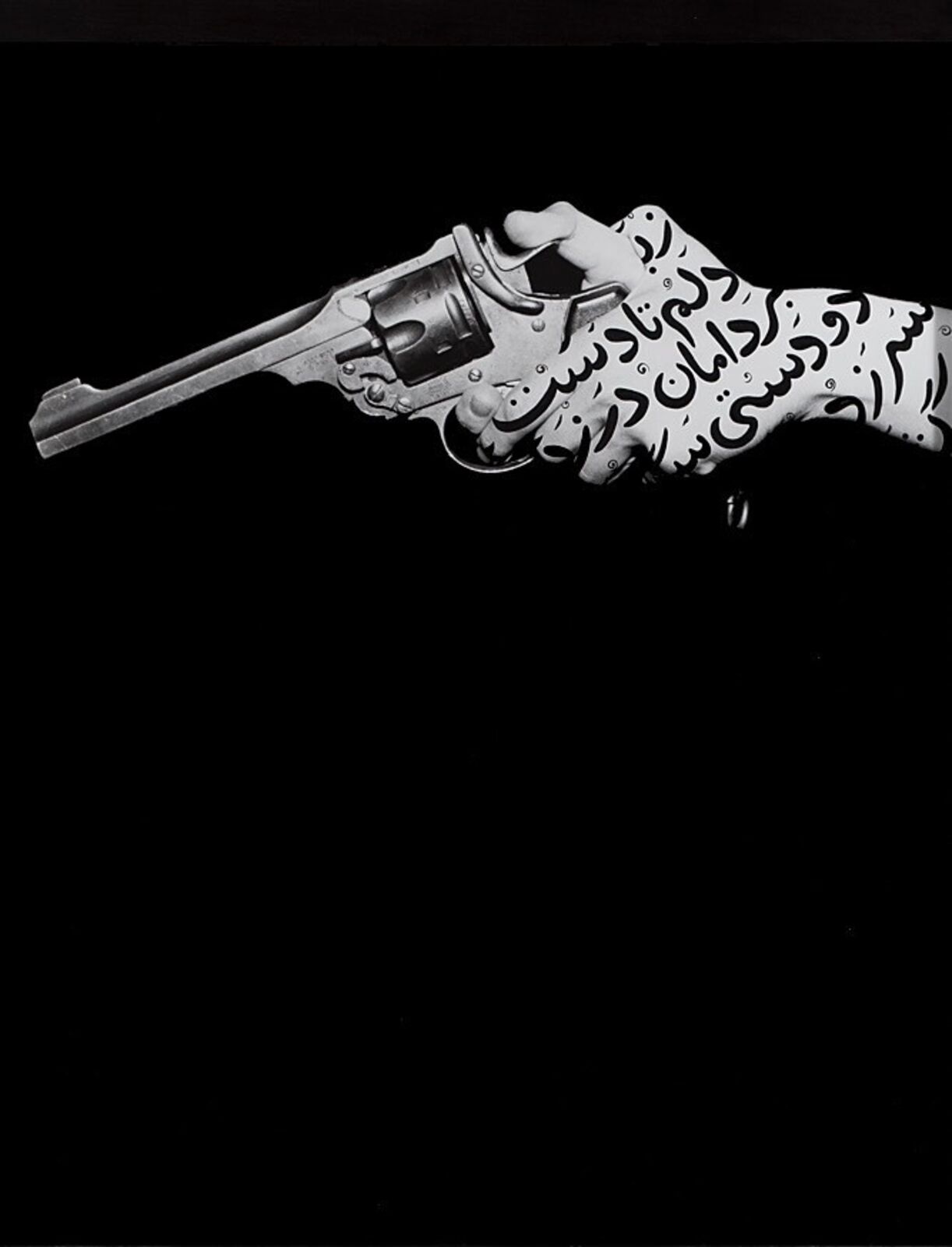 A black and white photo of a hand holding a revolver.