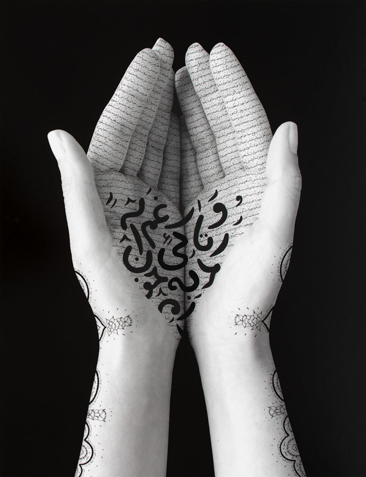 A pair of hands with arabic writing on them. 
