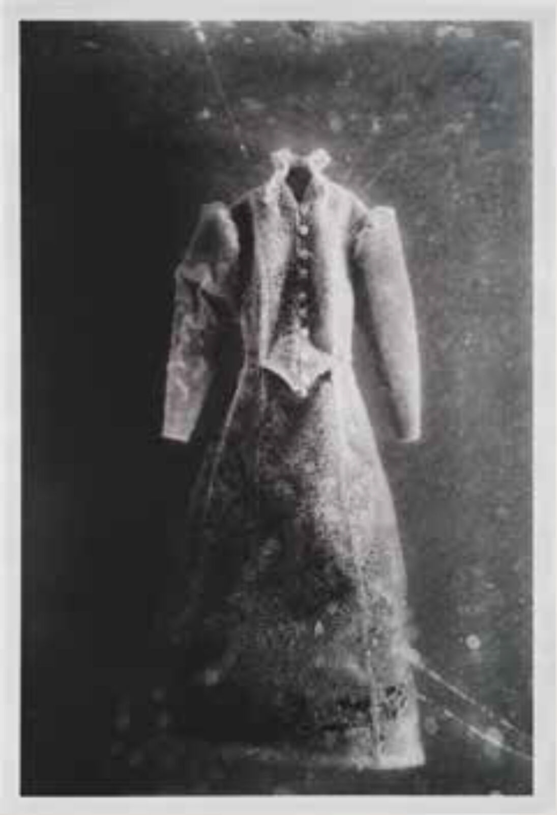 A black and white photo of a dress on a mannequin.