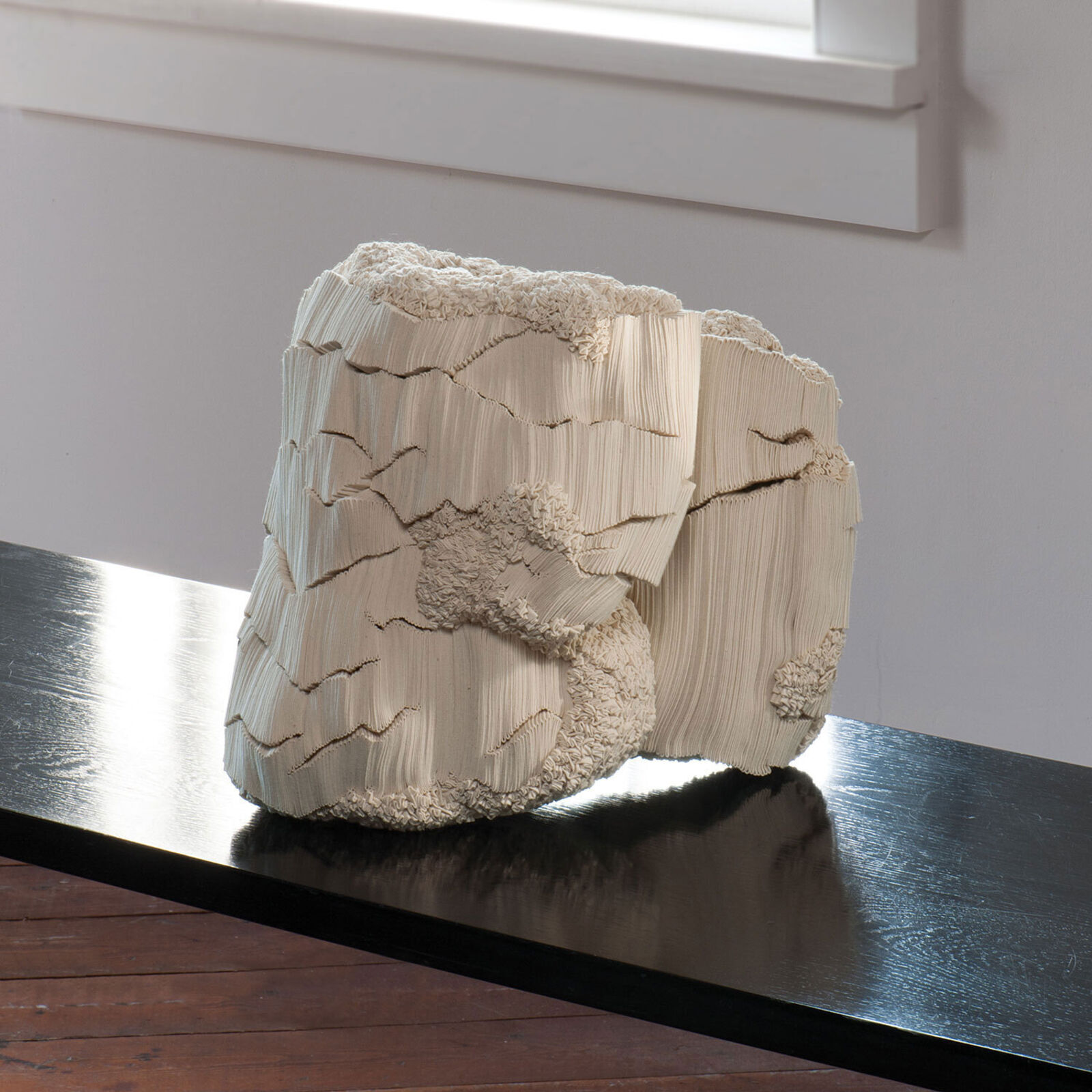 A wooden sculpture sitting on top of a wooden table.