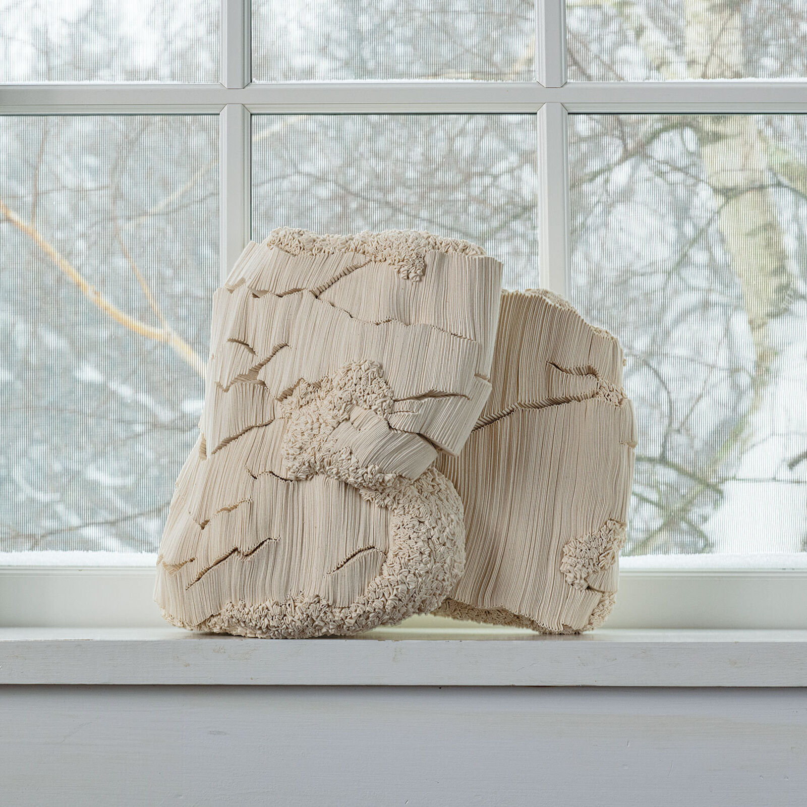 A wooden sculpture sitting on top of a wooden table.